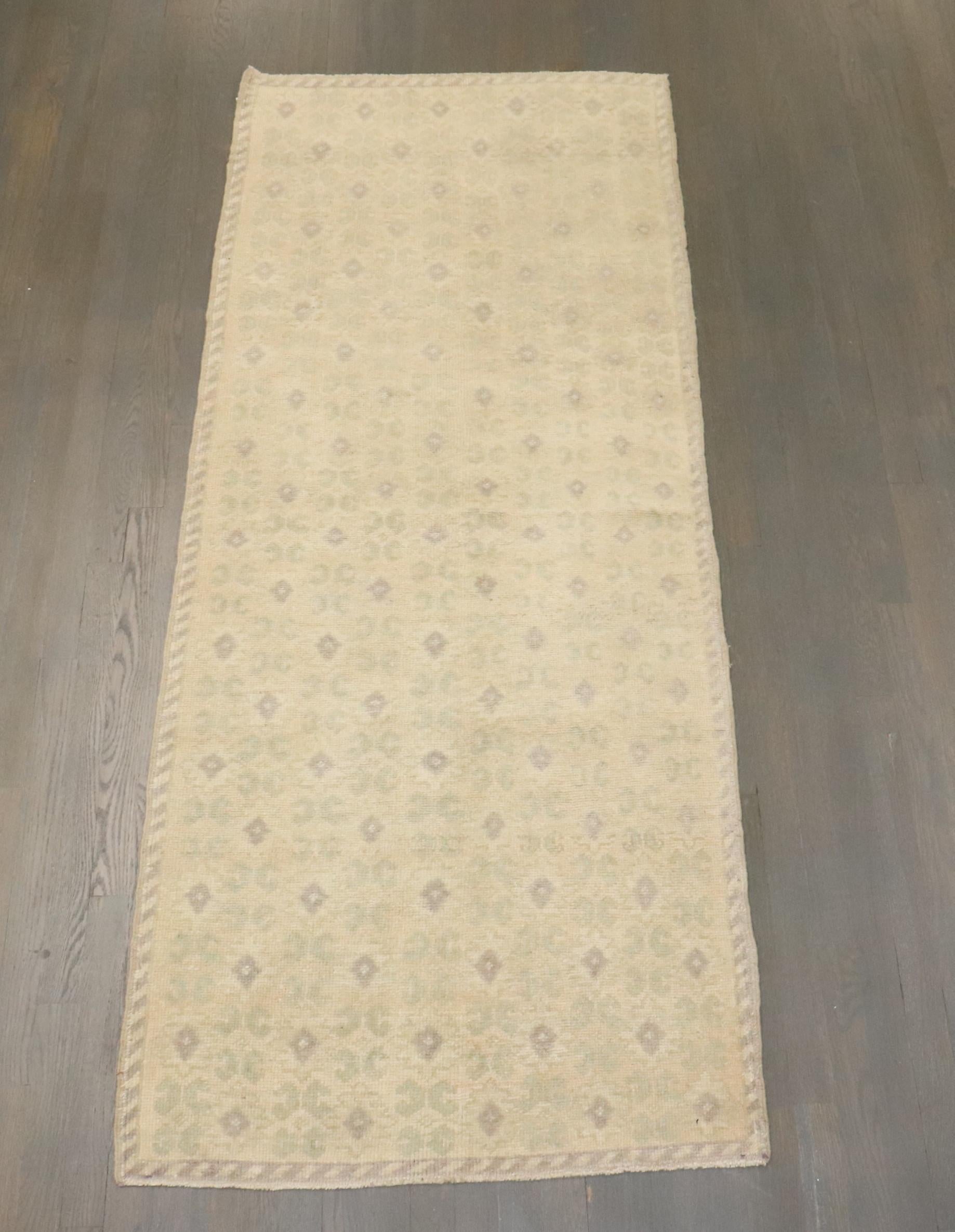 Vintage Turkish runner with an all-over floral design with gray and soft green accents on a beige ground,

circa mid-20th century, measures: 2'11