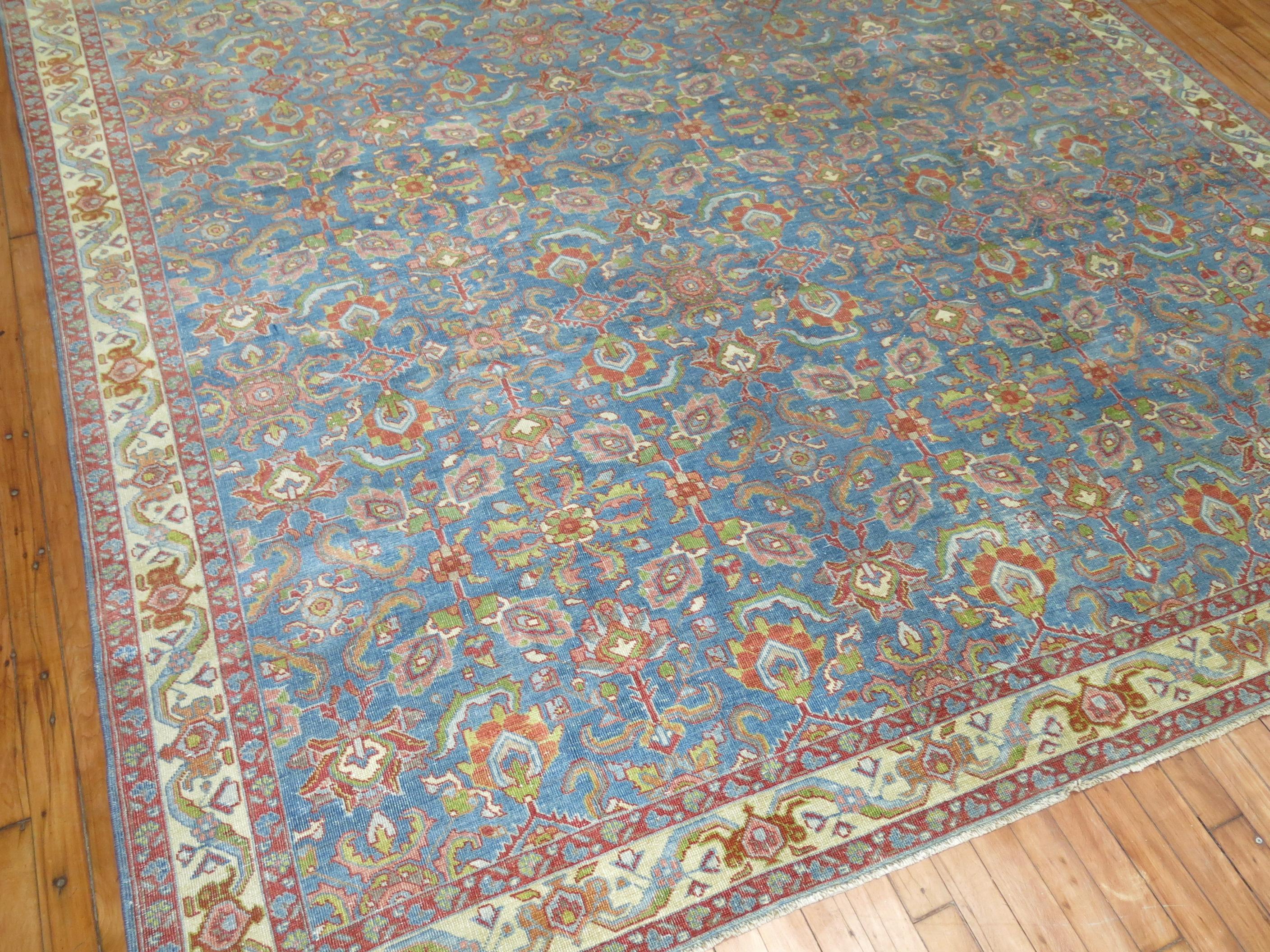 an early 20th Century Persian Mahal room size rug with a blue ground

Measures: 8' x 12'5''

Woven in a series of villages in Western Central Iran, Sultanabad carpets employ over-scale, spacious all-over patterns that are highly prized for their