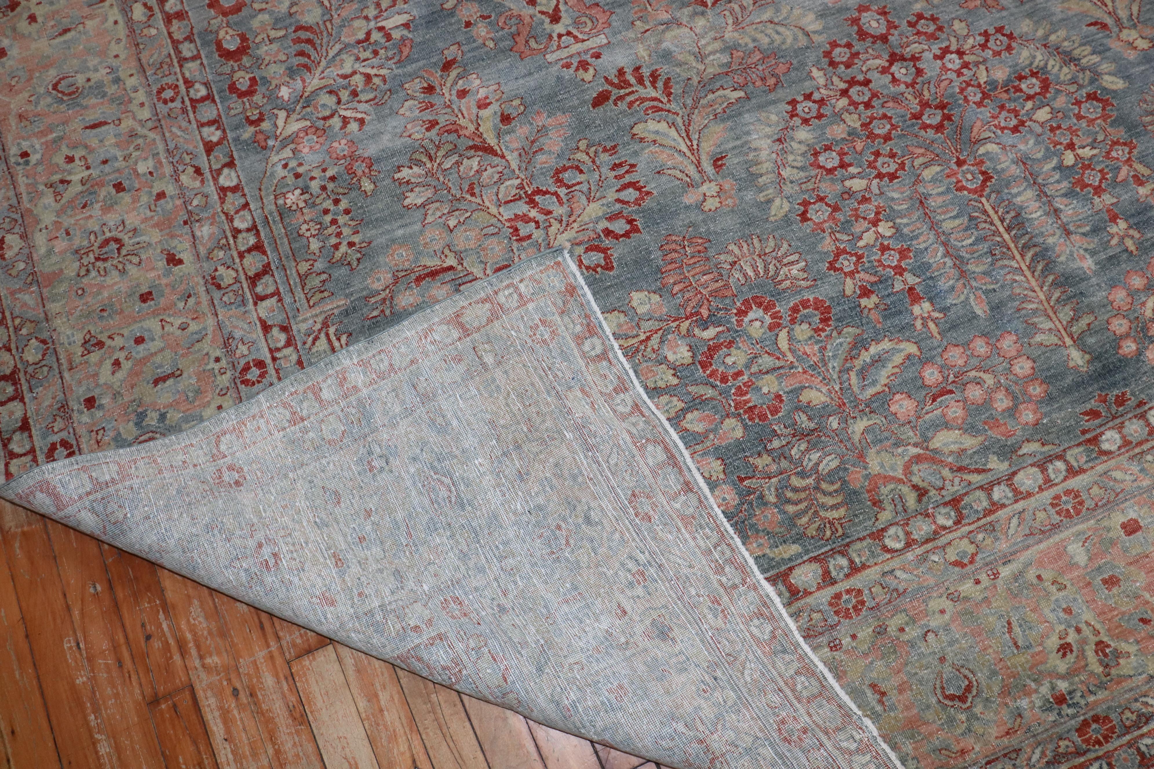 An early 20th century Persian  sarouk in blue , red and pink

8'10'' x 11'5''

.