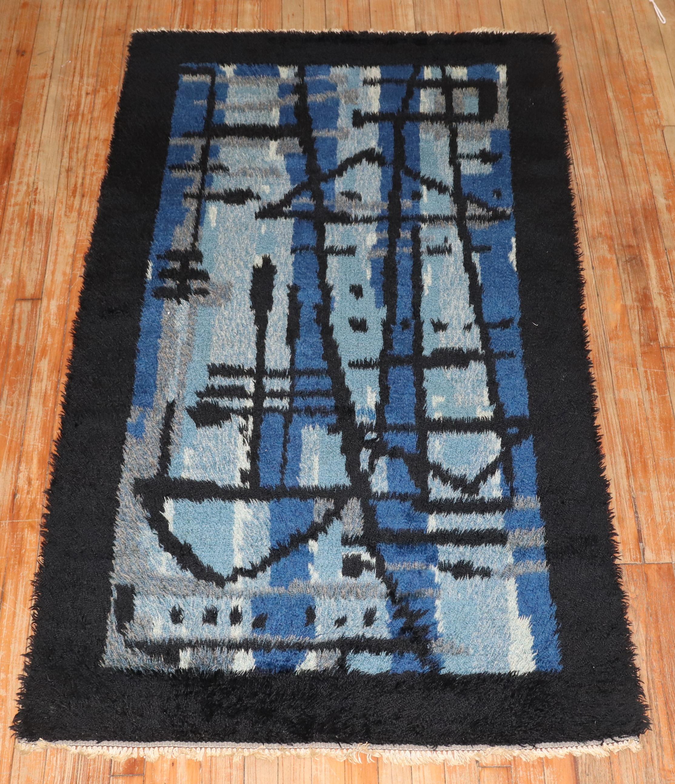 A plush Swedish Rya rug from the Mid-20th Century in various shades of blue and a dark border

Measures: 3'6” x 6'3”

Swedish Rya rugs are extremely colorful, lovely and quite chic and each have their own character to them. They tend to have thicker