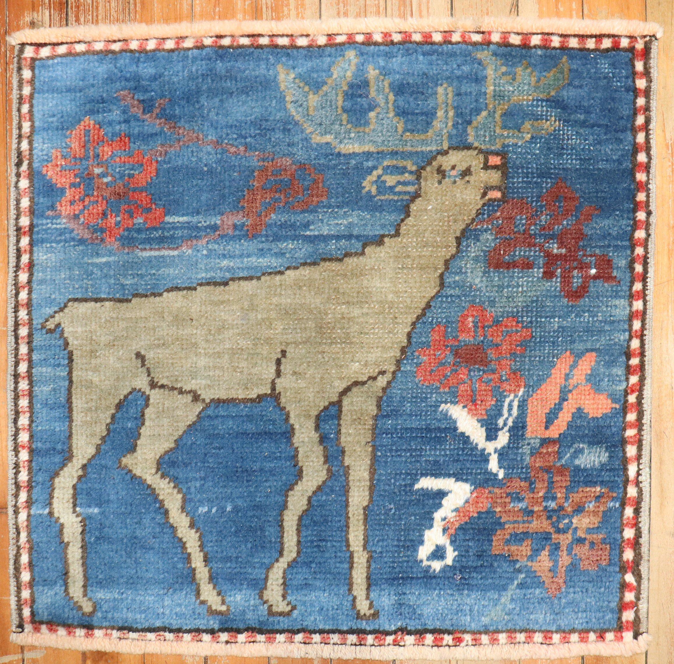 mid 20th century Turkish Rug with a reindeer on a blue field with flowers hovering around

Details
rug no.	j3837
size	1' 9