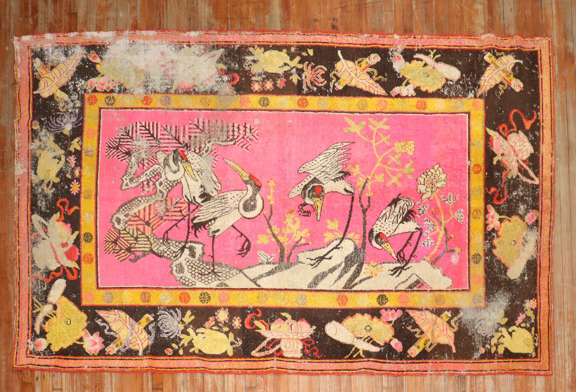 Late 19th Century distressed antique samarkand khotan rug with 4 flamingos hovering over a bright pink ground

5'10'' x 10'.

