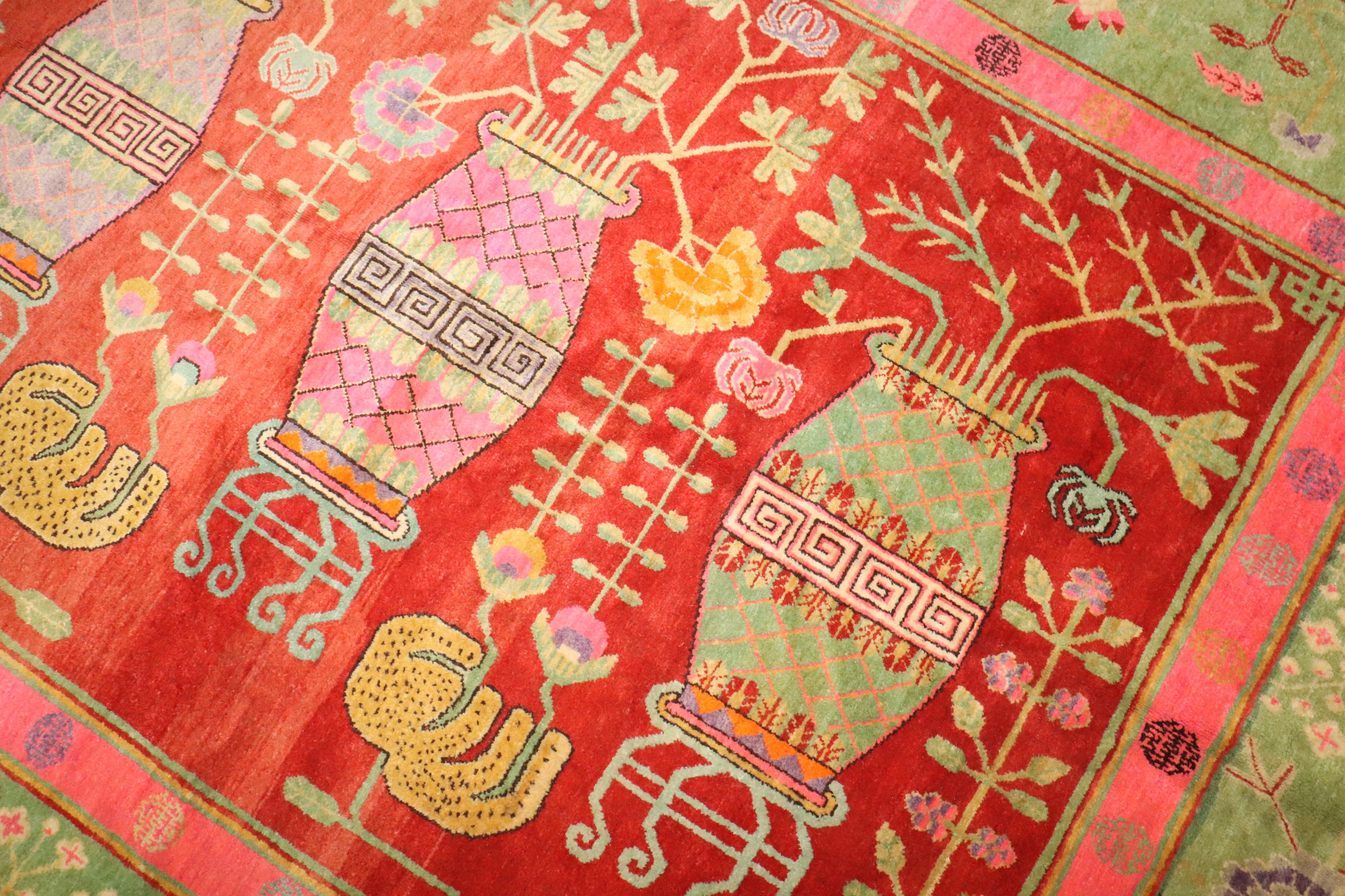 an early 20th century Samarkand Khotan Rug with an all over vase design highlighted with bright pink and lime green accent colors. 

Details
rug no.	j4367
size	5' 7