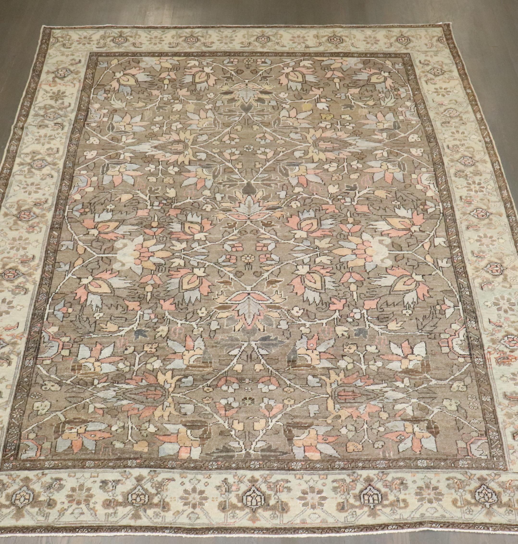 An early 20th century room size Persian Heriz in predominantly brown.

Measures: 8'8'' x 11'1''.