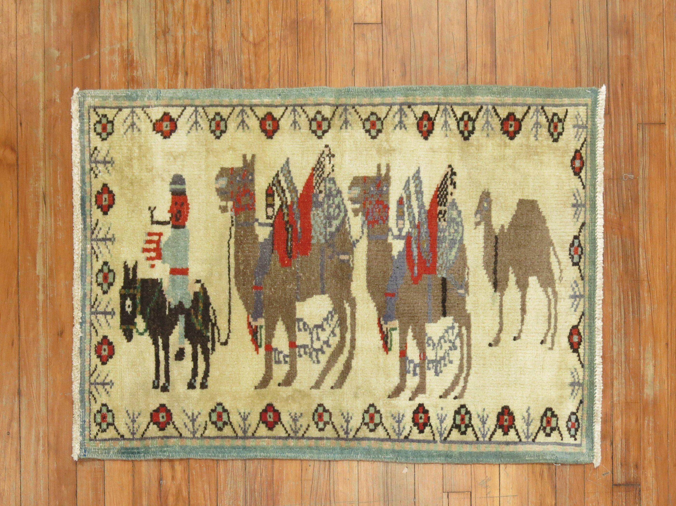 A mid 20th century hand-knotted Turkish Rug with 3 brown camels hooked on a small black horse and a human figure

Details
rug no.	31332
size	2' 5