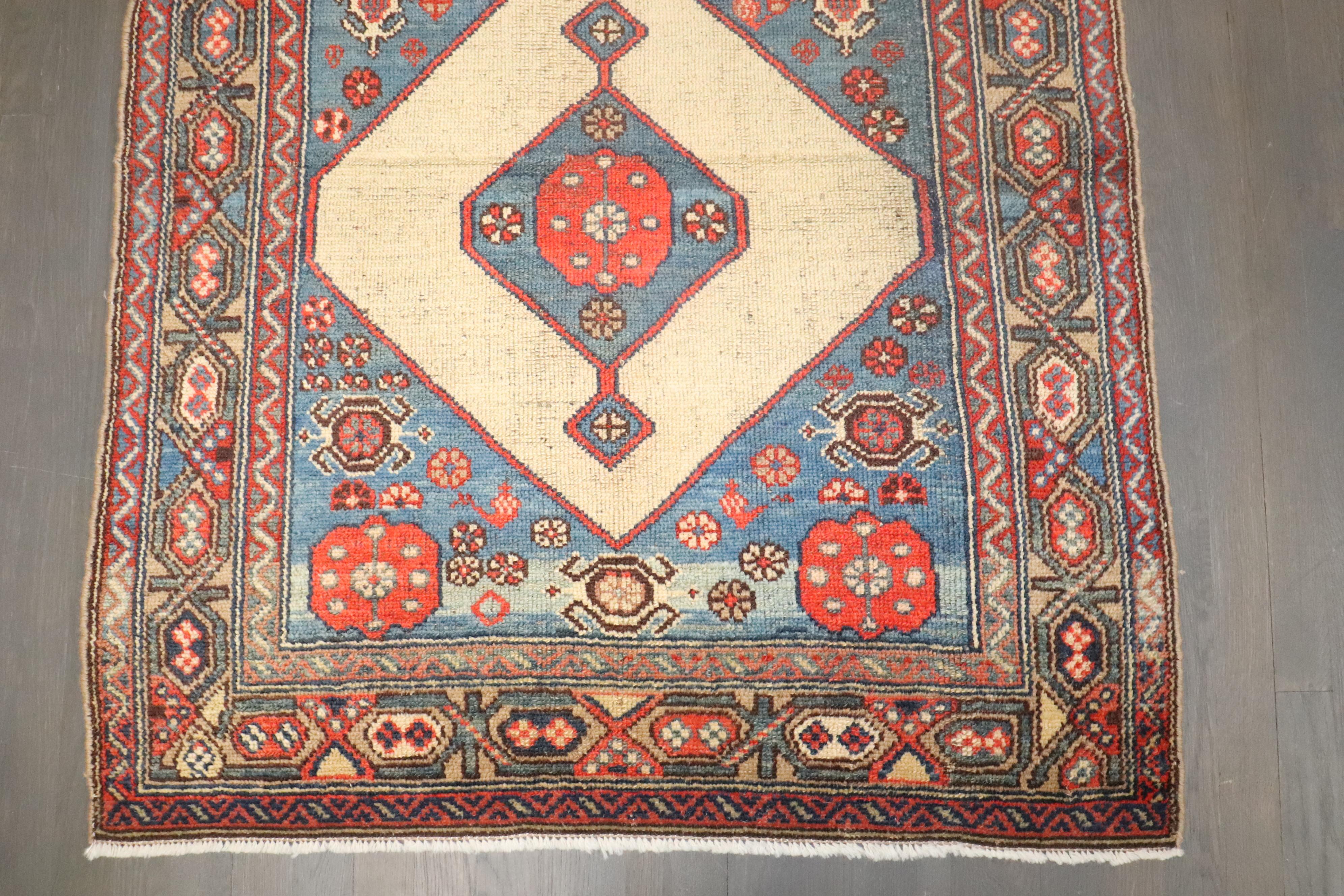 An early 20th century Persian Serab mat. Light blues, coral, on a camel field. 

Measures: 3'4