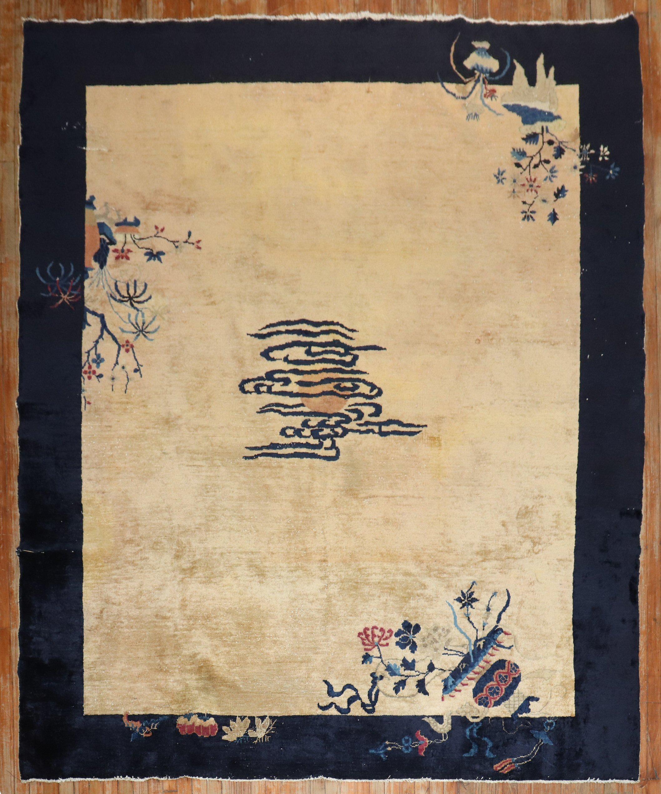 An authentic early-20th-century Chinese rug with a spacious open field floral design with an eclipsed medaion on a tan ground.

Measures: 8' x 9'8''.