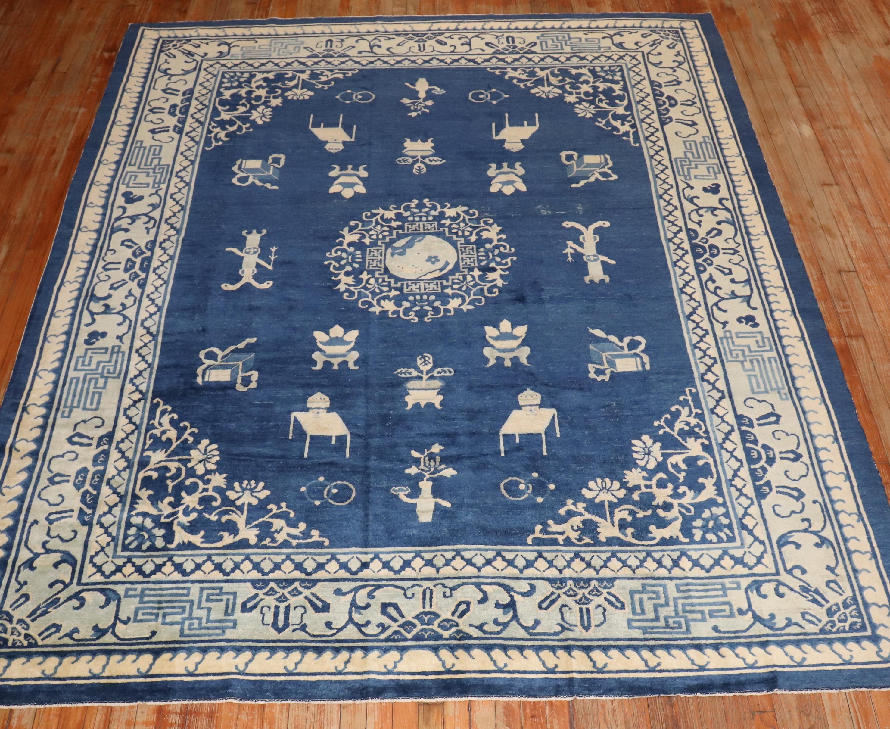 an early 20th century room size chinese rug in blues and creams

Measures: 8' x 9'9''