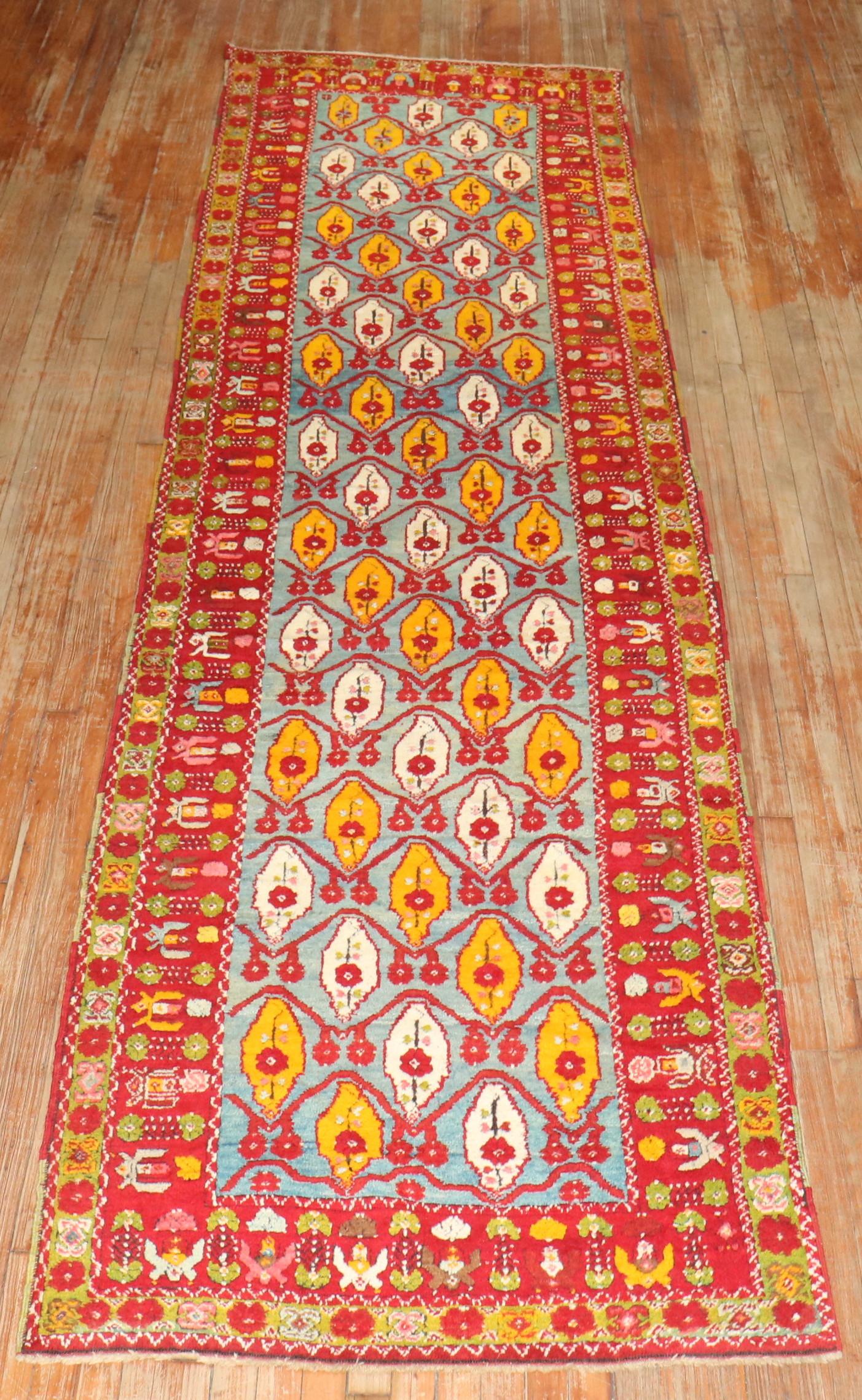 Antique Turkish milas runner featuring a Caribbean blue ground, accents in bright red and saffron,

 Measures: 3'7