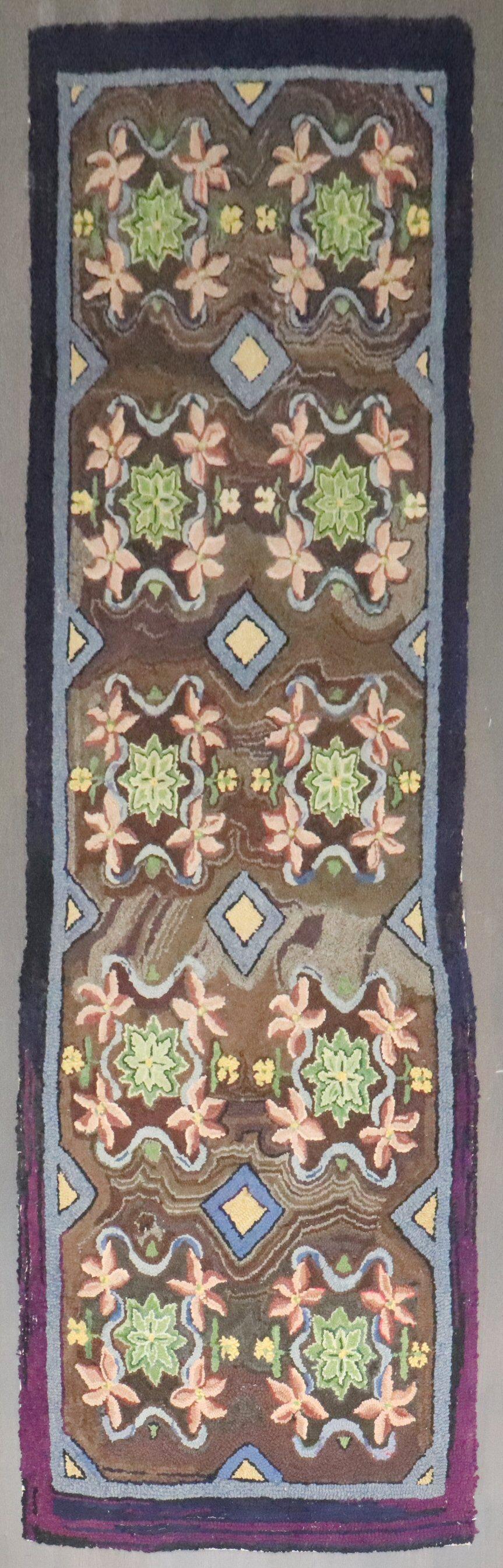 a floral motif mid-20th century American Hooked Runner

Details
rug no.	j4055
size	3' 3