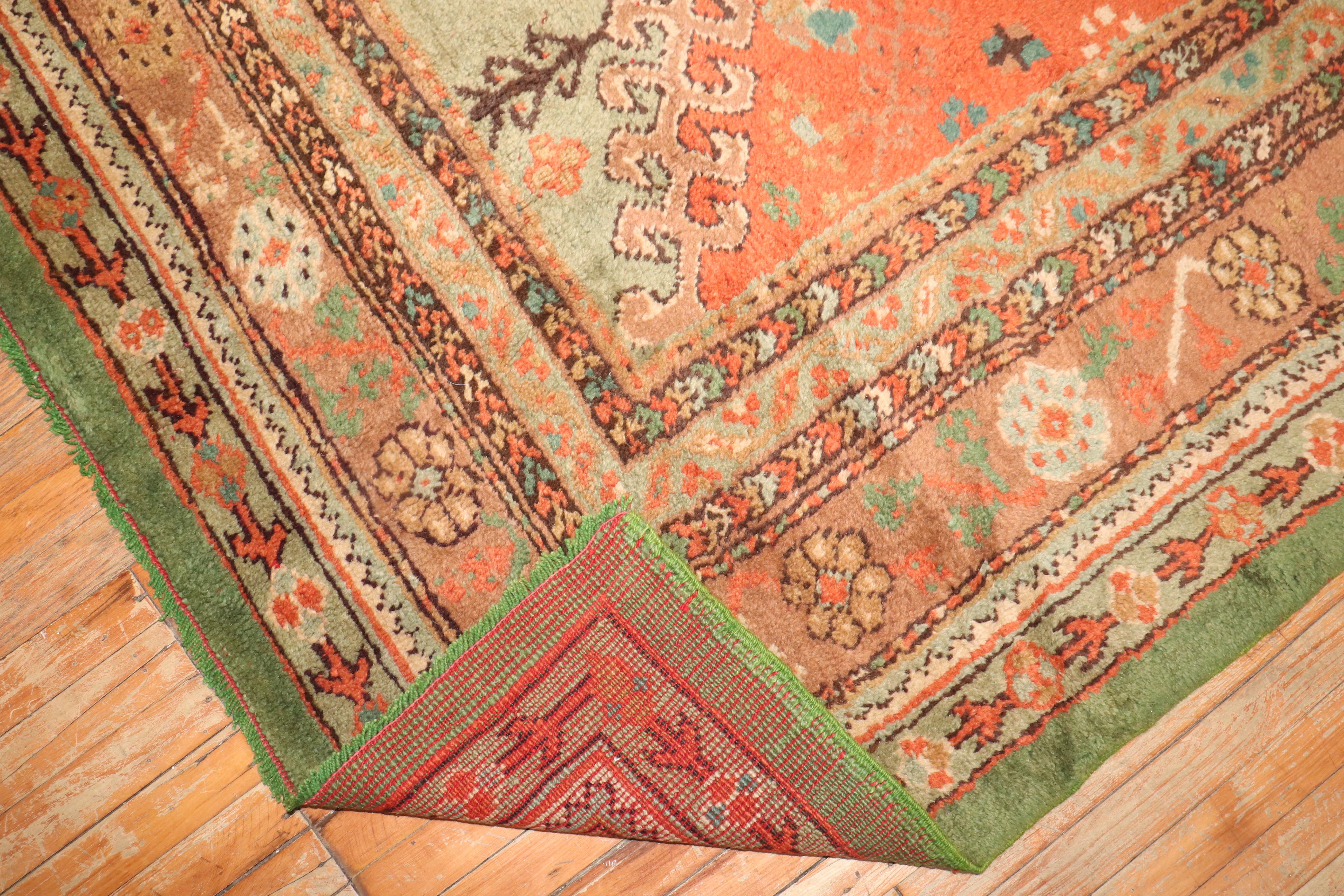 an early 20th Century Irish Donegal large square-size rug in a leprechaun green and pumpkin

rug no. j3121
size 13' 2