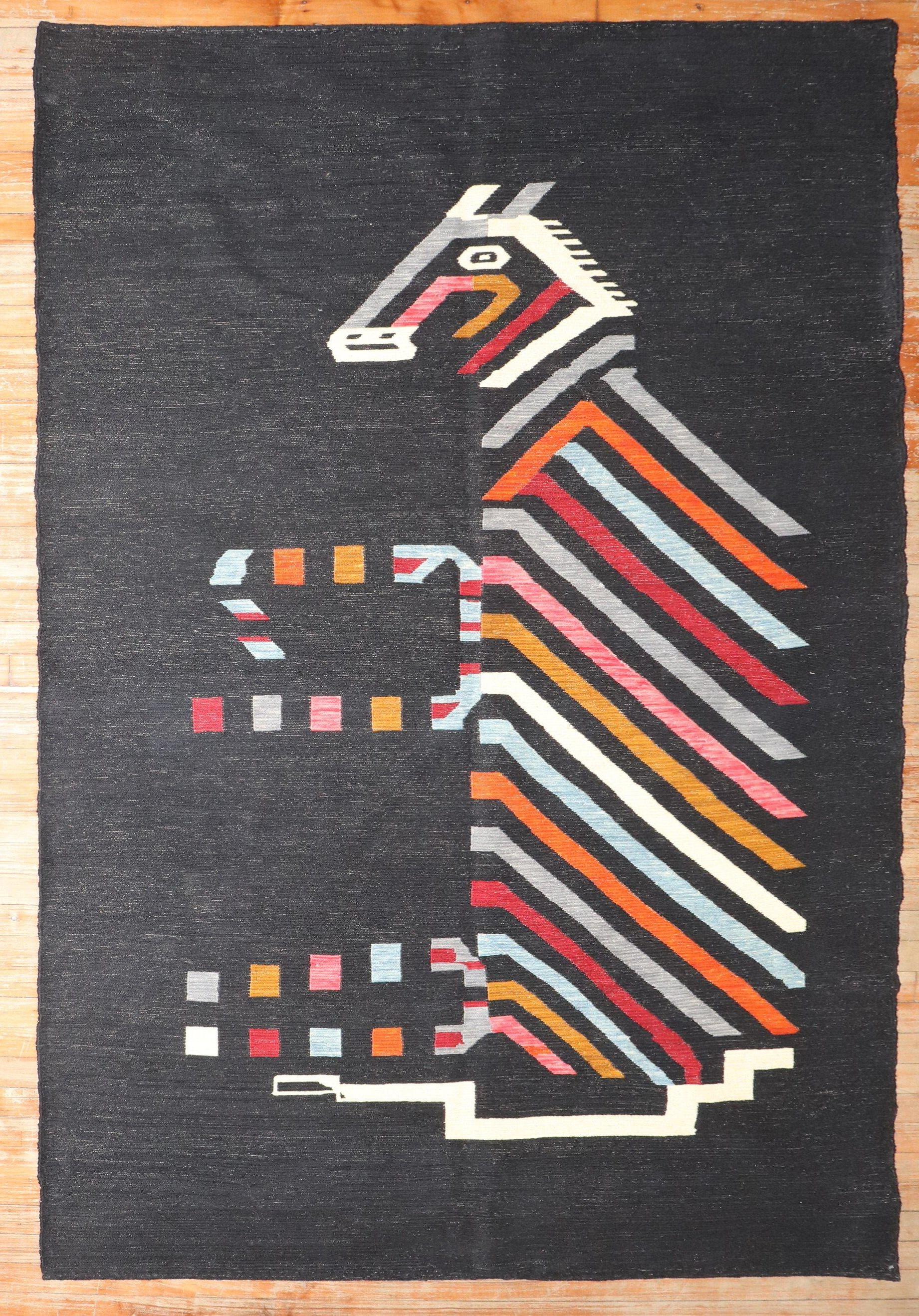 Accent size Persian Kilim from the late 20th century with what looks like a horse riding on a dark ground color

Measures: 4'10'' x 7'9''.

This was originally belonging to a private Persian collector who requested to make a custom collection of