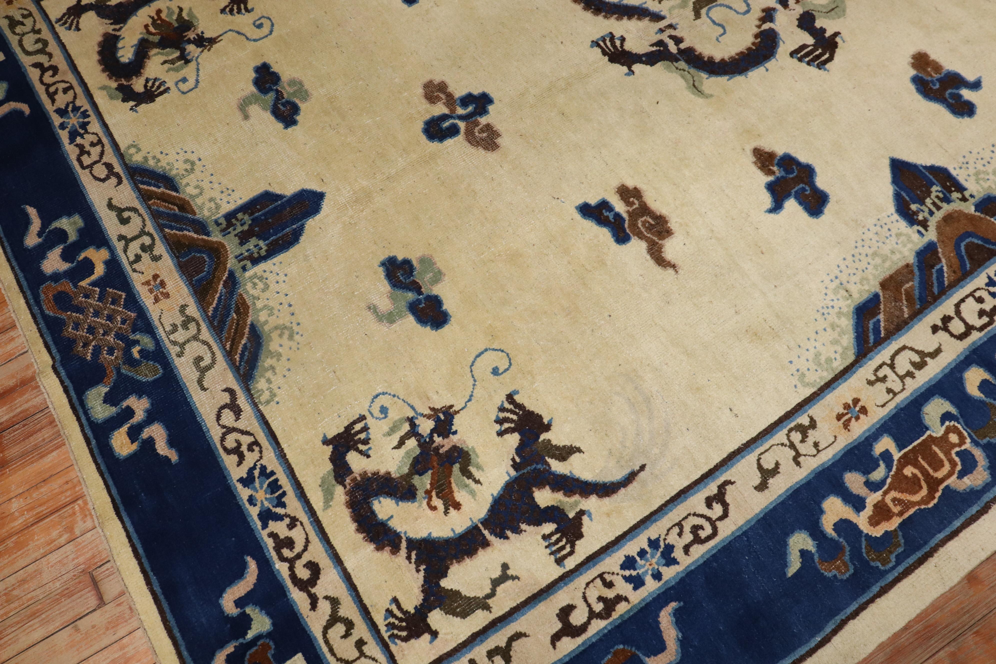 An early 20th century Chinese Peking Dragon motif rug with a spacious open field design on an ivory ground

Measures: 7'3'' x 9'7''

Chinese dragons are an important and powerful symbol in the eastern world and are sometimes find in Chinese