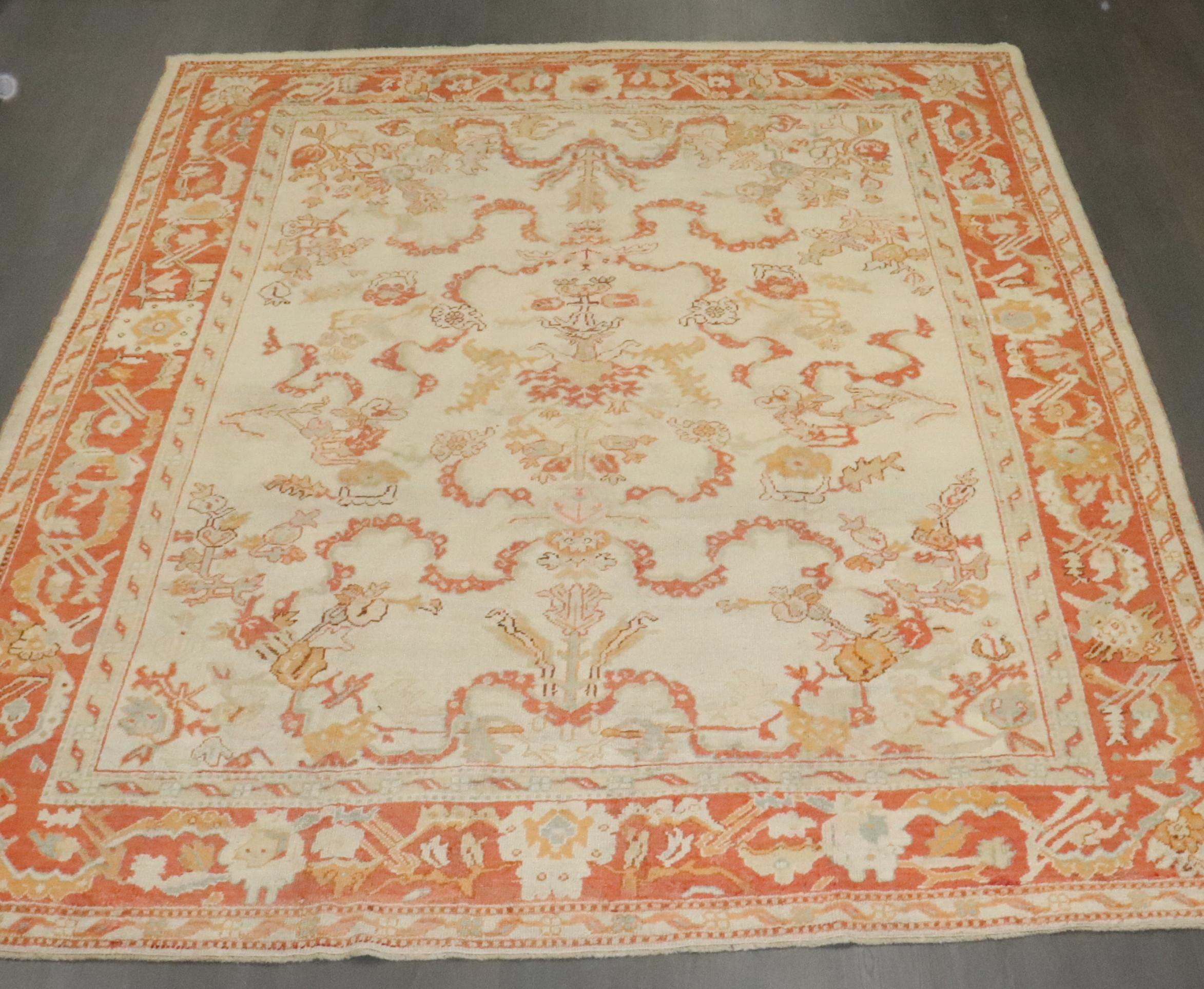 A late 19th century Turkish Oushak in predominant ivories and orange.

Measures: 10'7