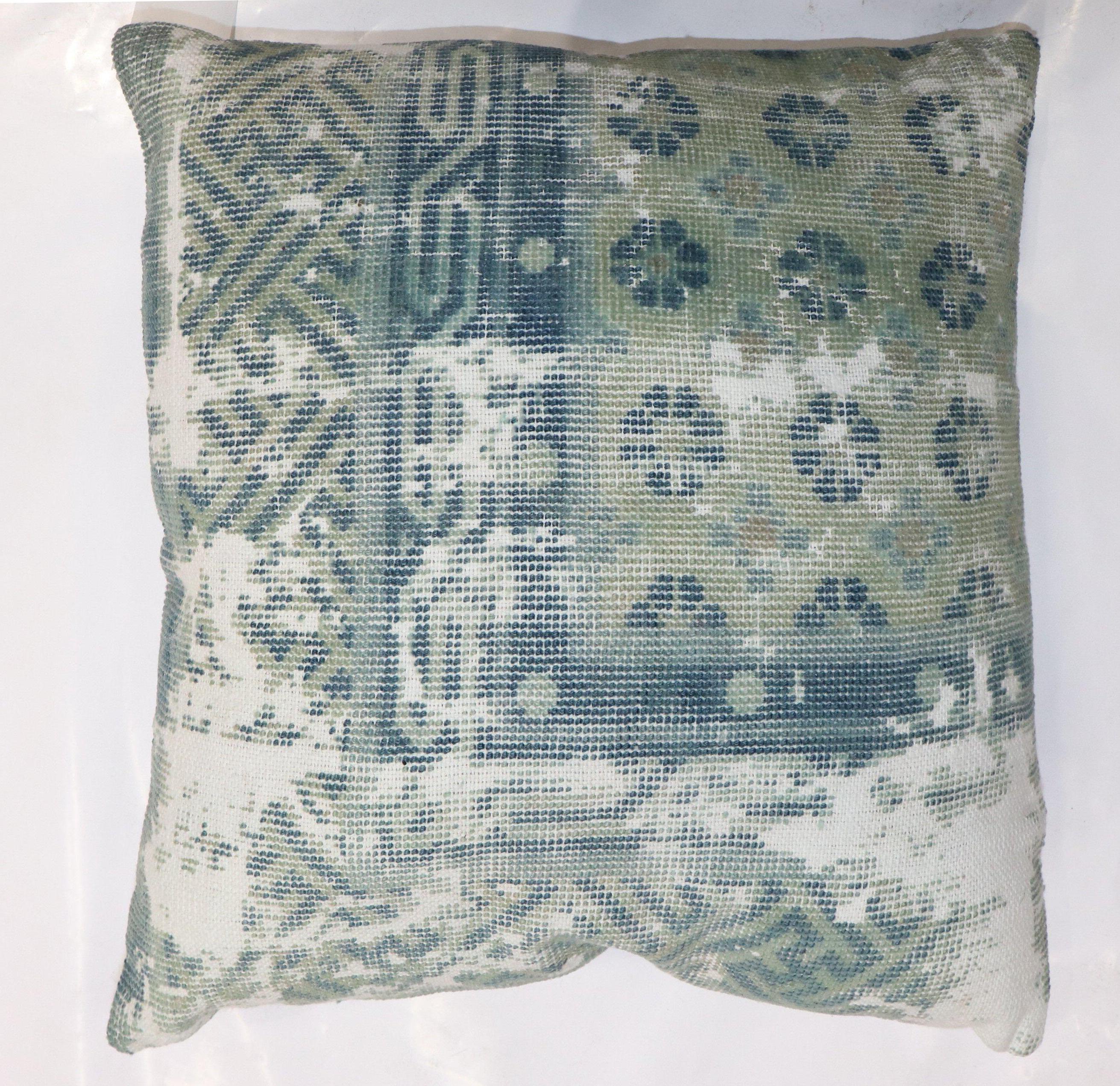 A pillow made from a worn 19th century worn antique Chinese rug.

20'' x 20''