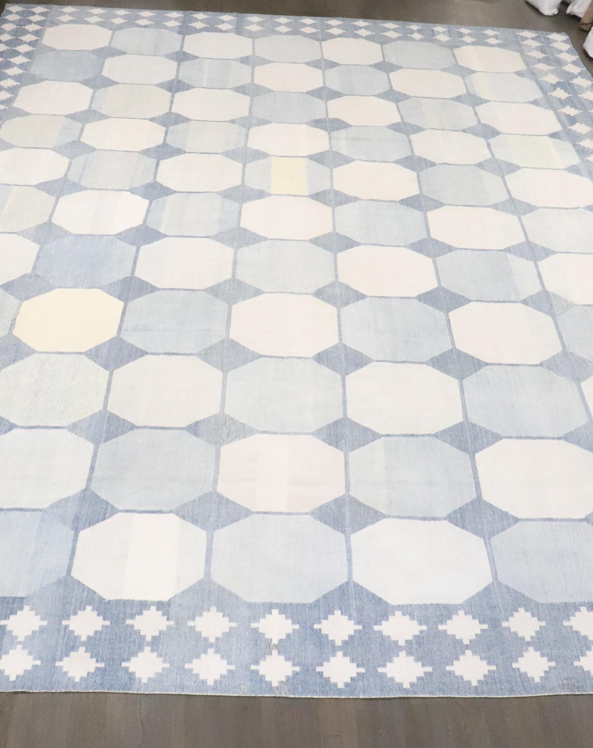 a large early 20th Century Indian Dhurrie rug in creams and light blue. some hints yellow. some minor spot stains which is normal for old dhurries

Details
rug no.	j4622
size	13' 7