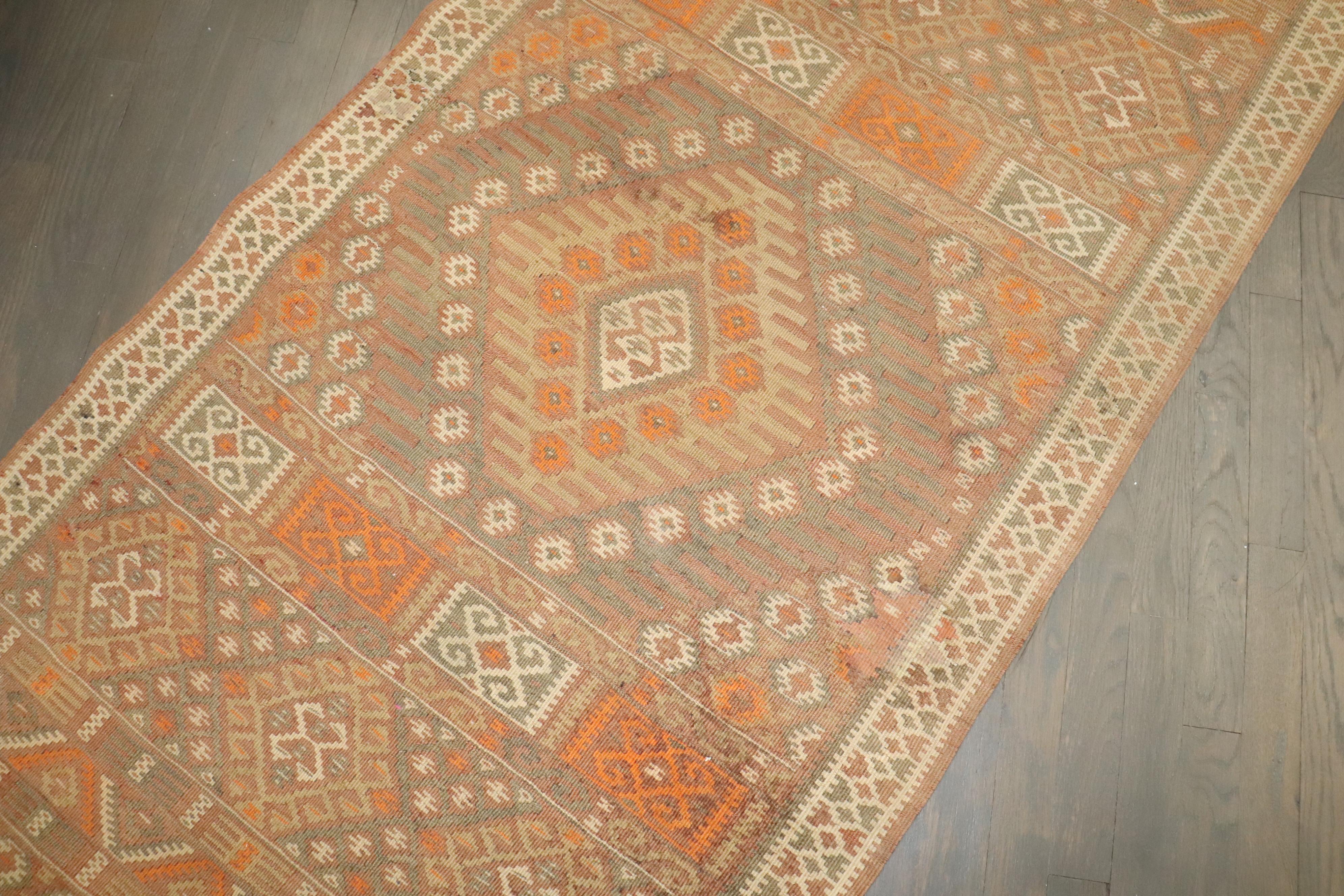 Kilim turco de mediados de siglo de tejido plano en el que predominan los tonos crema y naranja.

3' x 13'4''