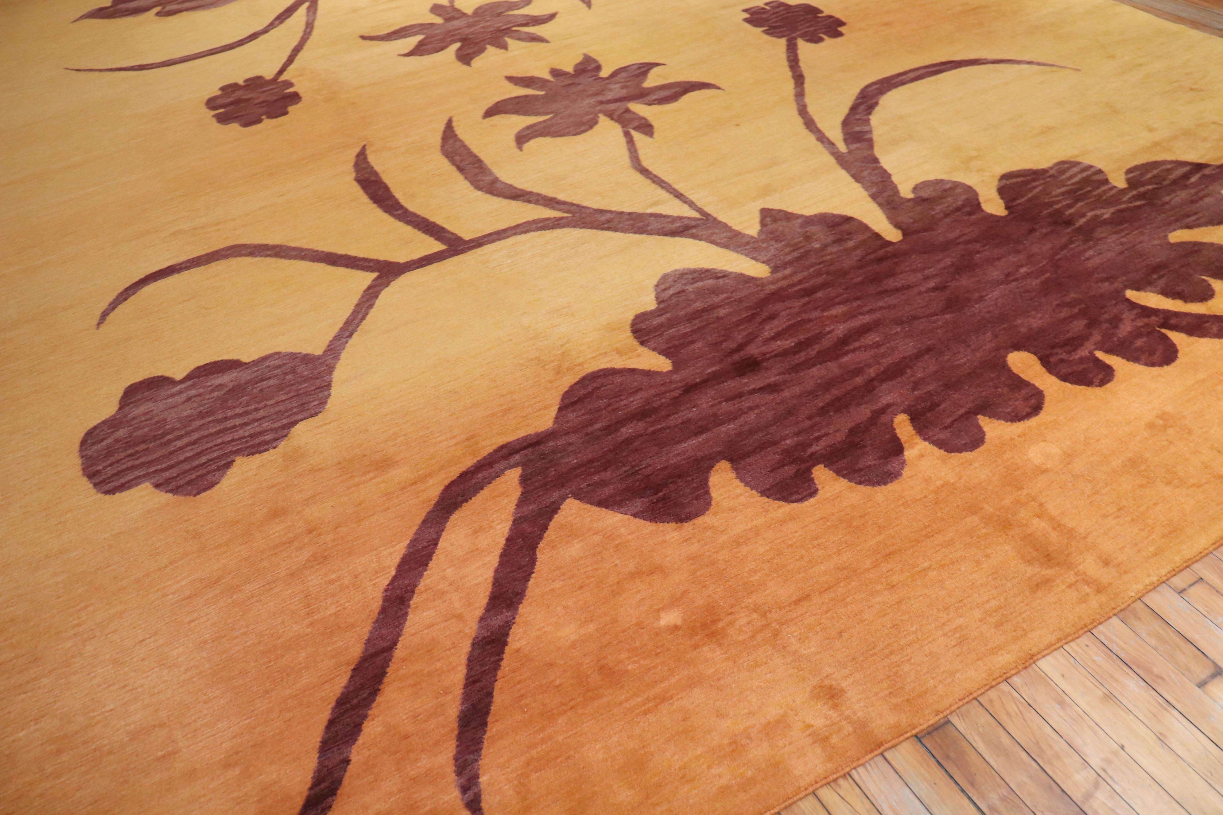 an oversize Tibetan Decorative Wool Rug with a large flora design on a borderless orange sherbert field

Details
rug no.	r5468
size	12' 8