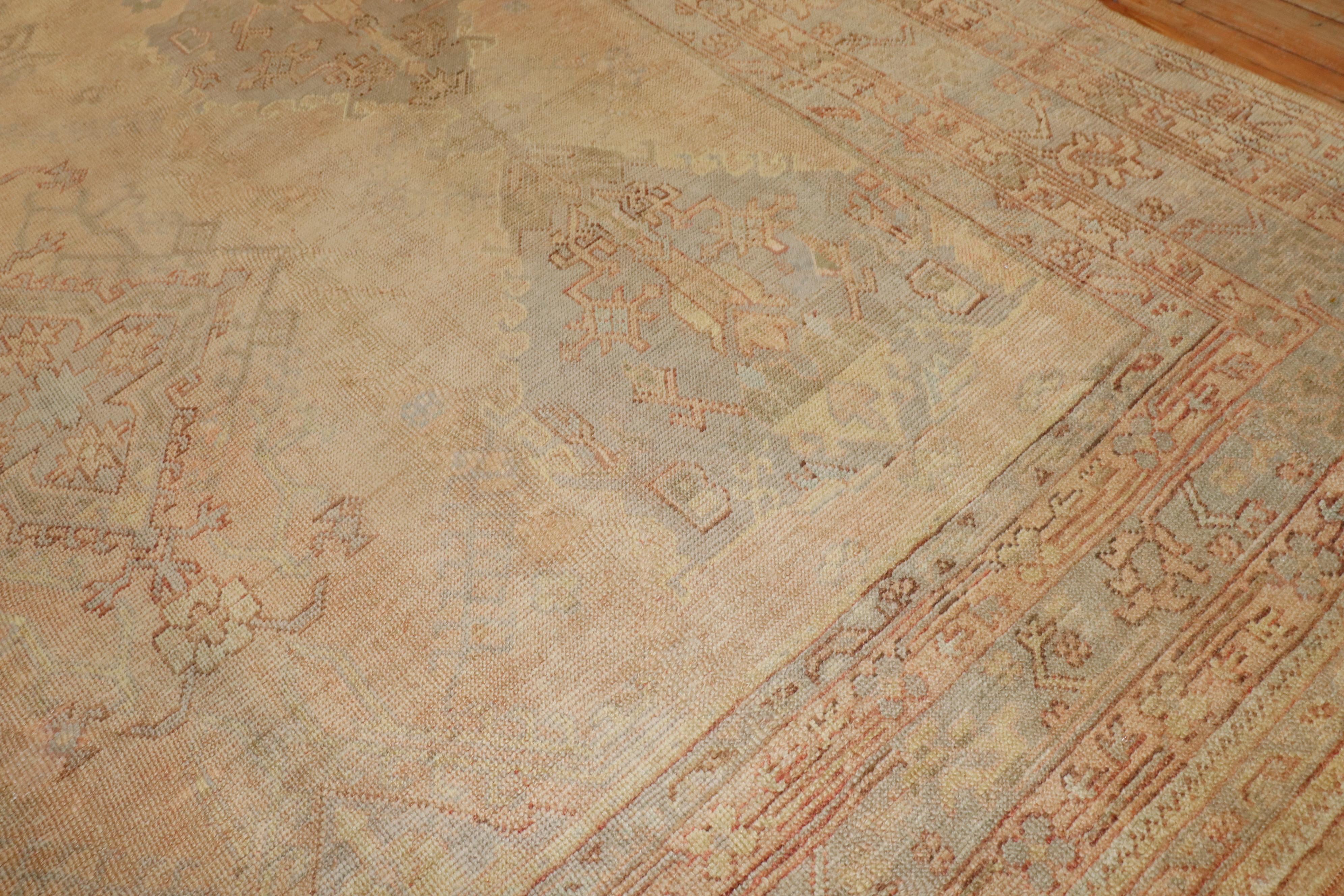 An early 20th-century oversize Turkish Oushak rug 

Measures: 11'2'' x 16'5