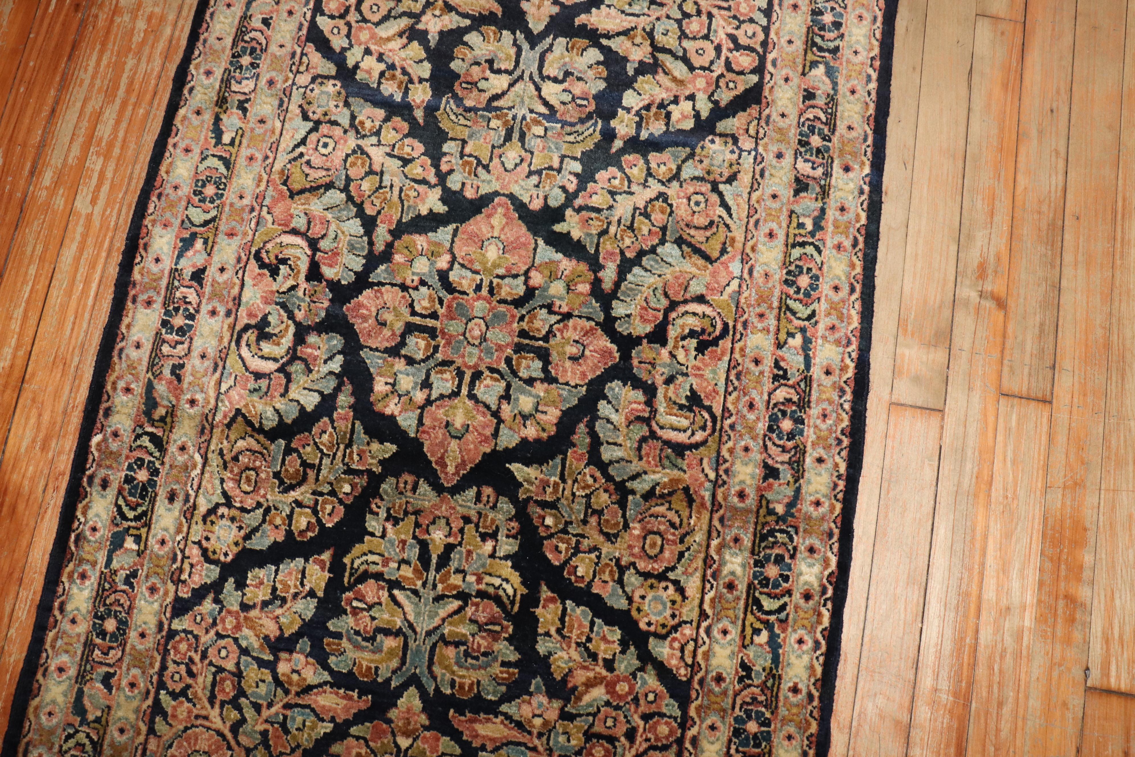 An early 20th-century traditional  navy fieldPersian Sarouk runner. 

Measures: 2'8'' x 11'1”.

.