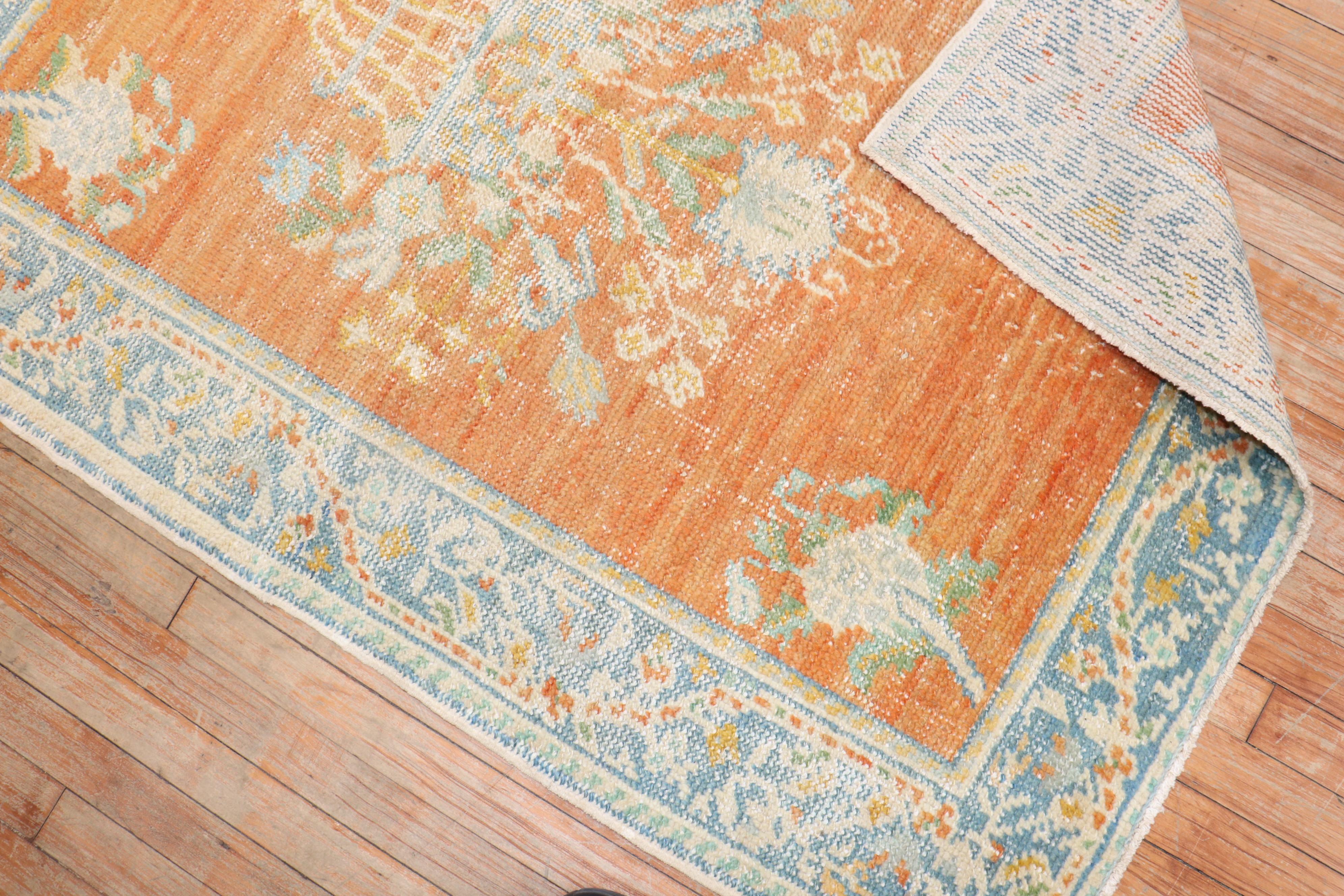 An early 20th-century orange field antique Oushak scatter size rug

Measures: 3'7” x 4'10”.