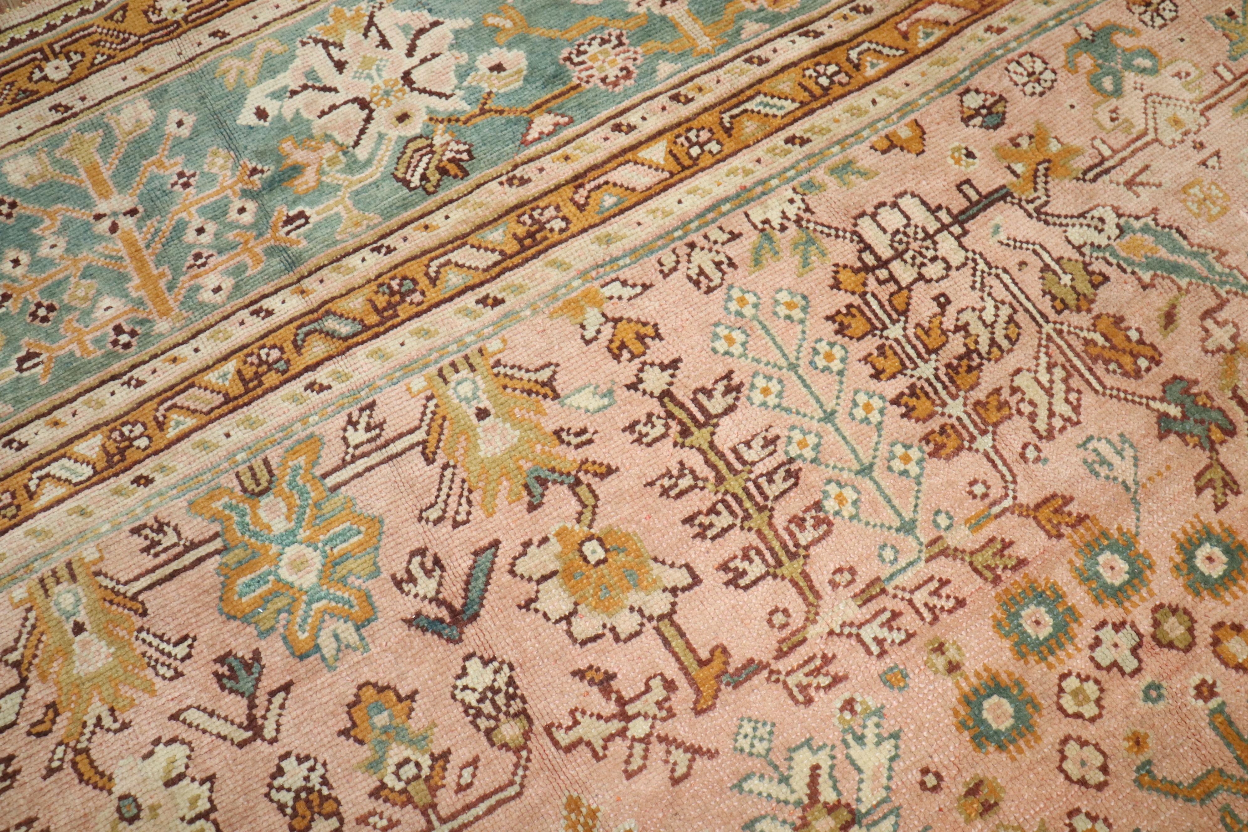 An early 20th century oversize square Turkish Oushak rug with an all-over design on a pink ground

Measures: 16'10'' x 17'