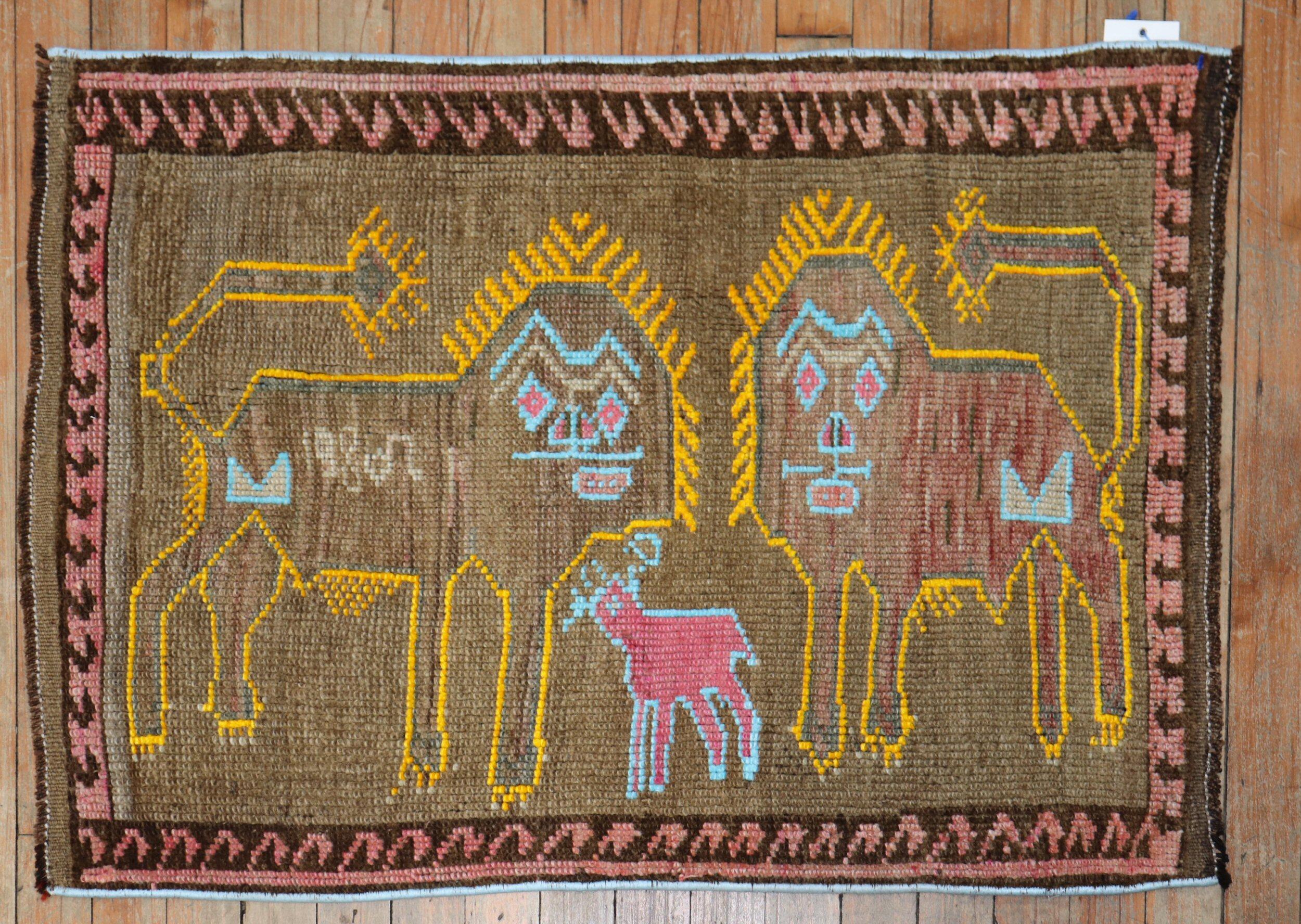 Alfombra turca de finales del siglo XX que representa 2 leones perfilados en amarillo y una oveja rosa perfilada en azul claro sobre un campo marrón.
todos parecen muy felices, ¿verdad? fechada en 1980

Medidas 2'