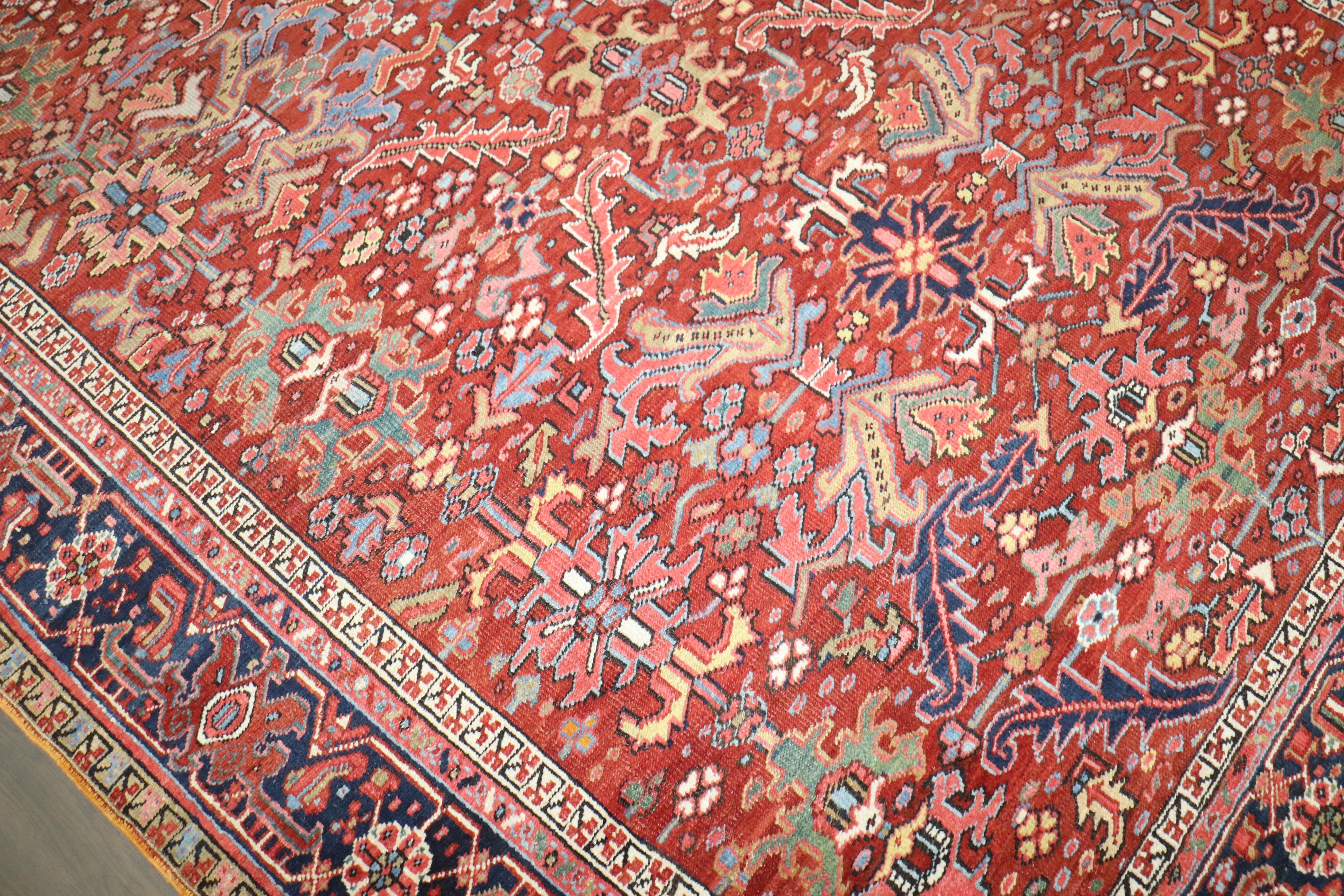 An early 20th century Persian Heriz room size colorful rug. An all-over geometric design on a red field

Measures: 7'4'' x 10'6''.