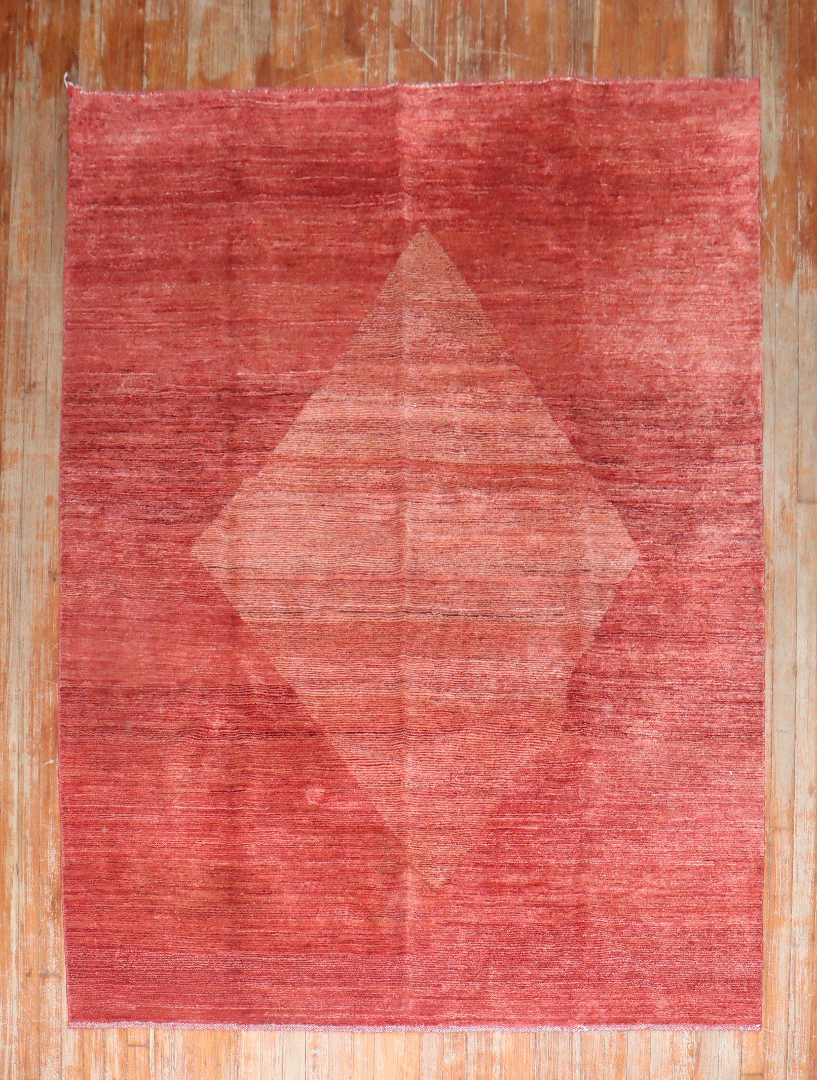 One of a kind intermediate size Persian Gabbeh rug from the late 20th century featuring a large irregular shape soft color medallion on a spacious borderless red ground

Measures: 5'10'' x 7'10''.