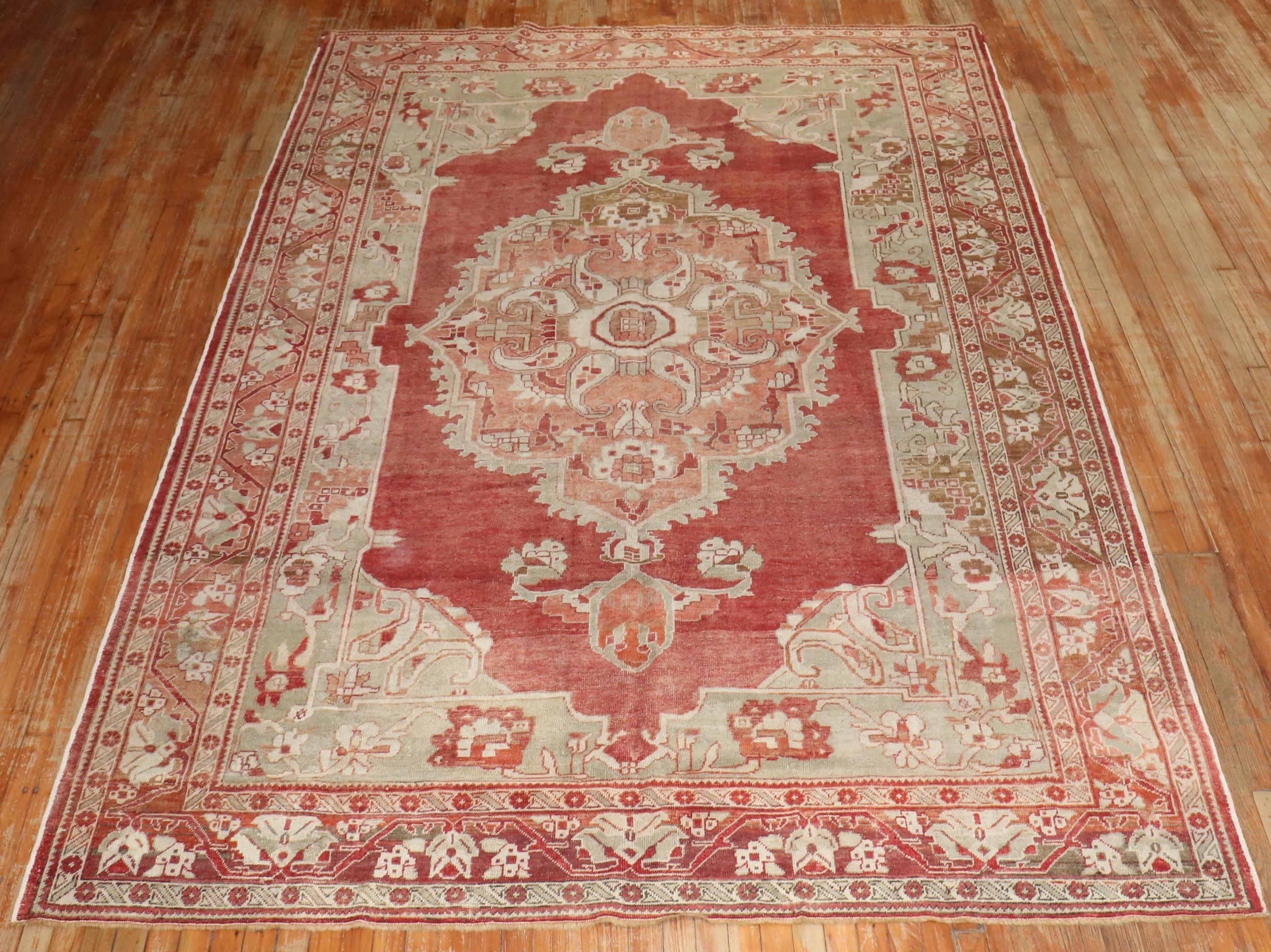 An antique Turkish rug from the early 20th century in a room-size format. 

Measures: 7'7'' x 11'6''.