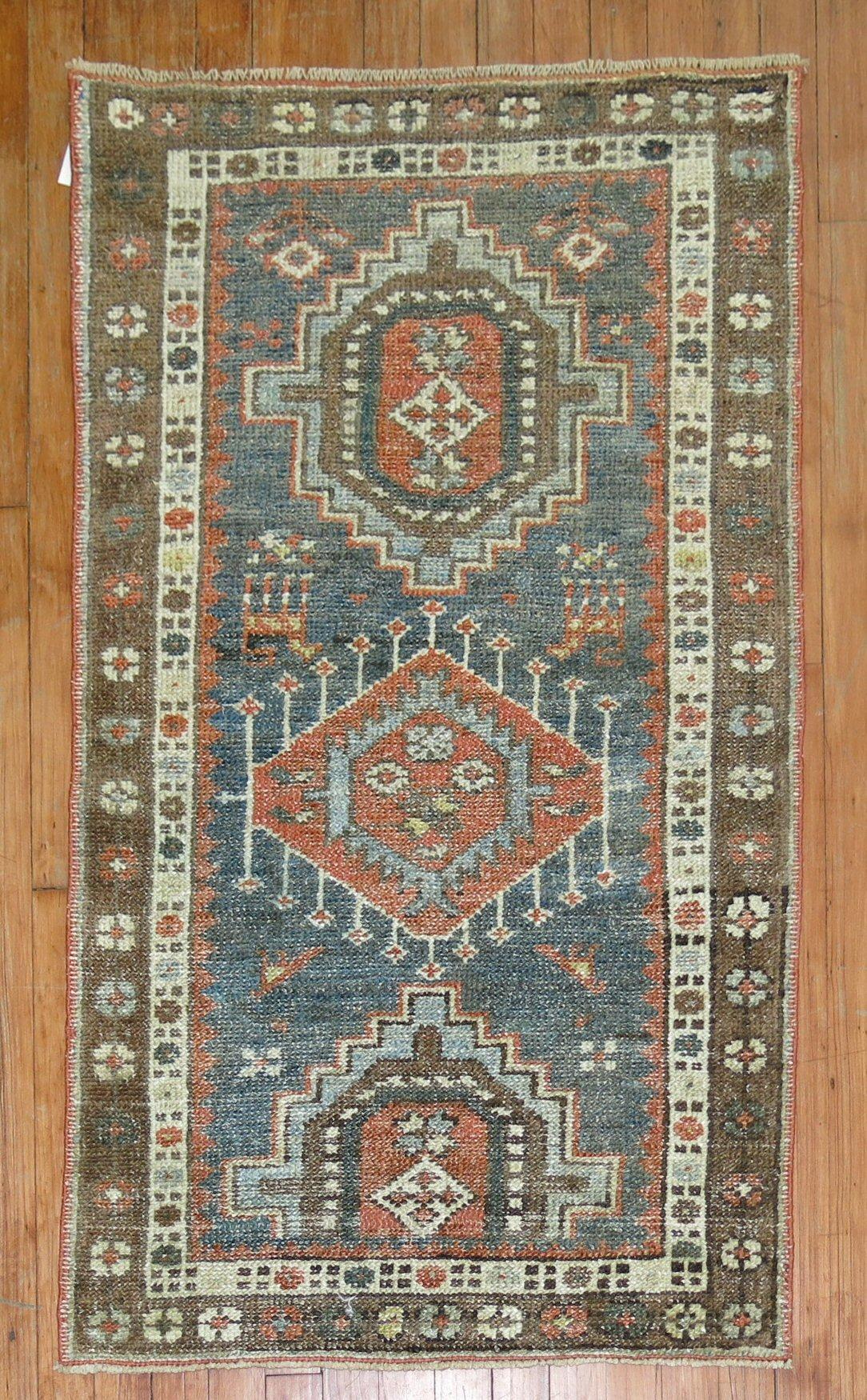 Persian Heriz Tribal scatter rug in rustic tones from the early 20th century

Measures: 2'5” x 4'1”.