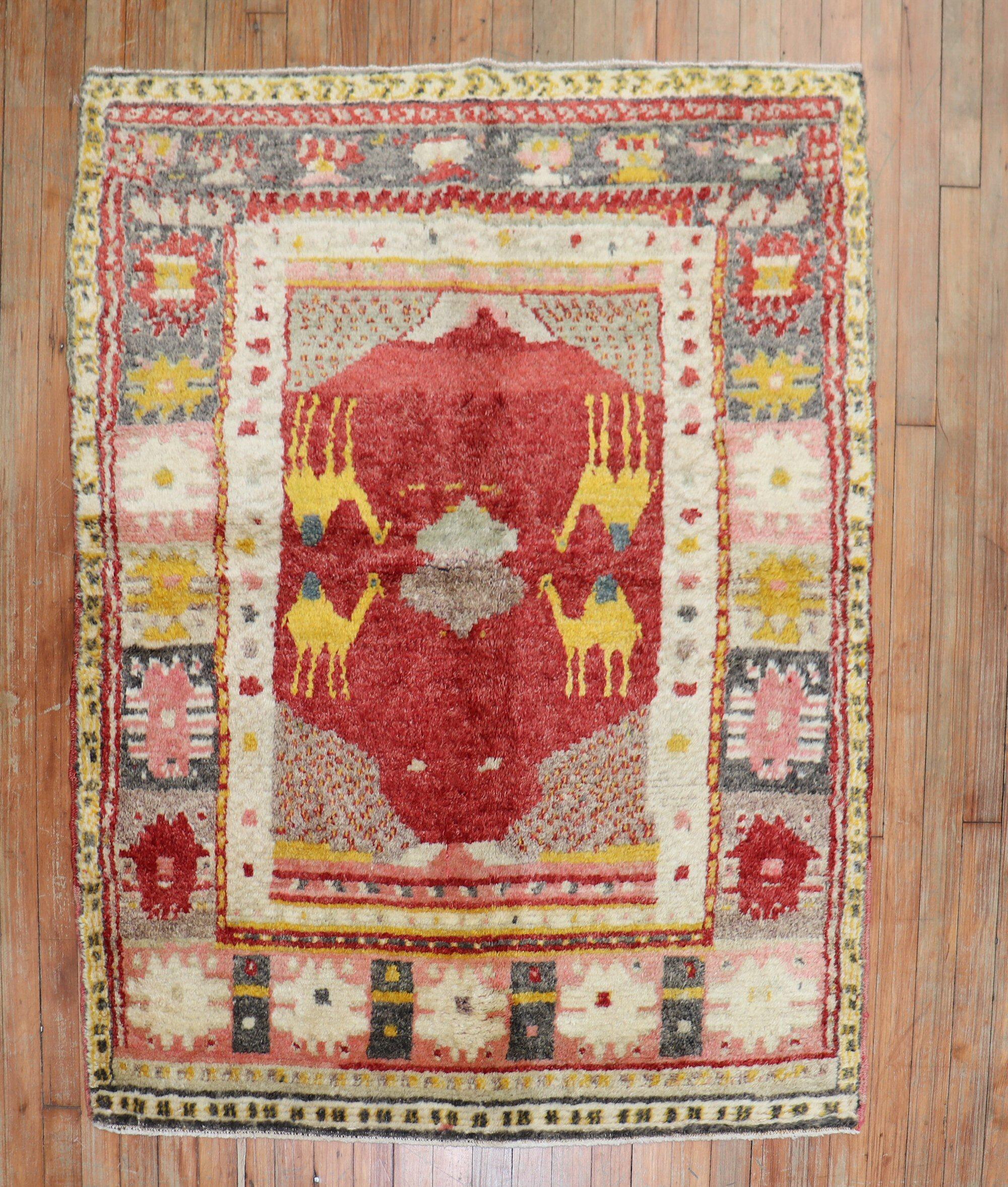 A scatter size village Turkish Rug with 4 gold camels on a bright red field hand-knotted in the middle of the 20th century

rug no. r5501

size 3'9