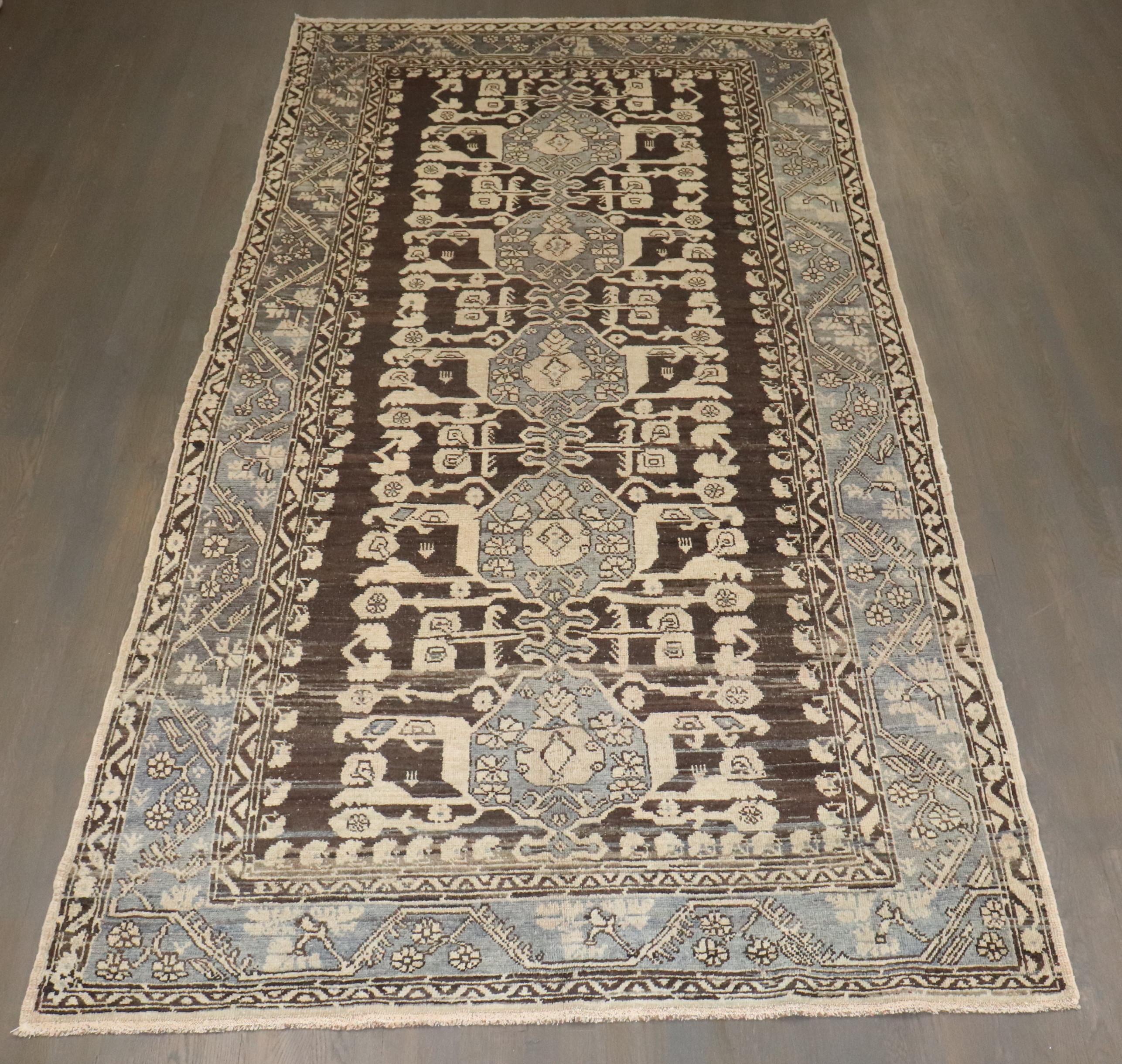 The town of Kula, was one the most prolific weaving centers in the country of Turkey for centuries. The charcoal background makes this rug very decorative and the peculiar motif is a characteristic of this group of rugs woven in turkey.

5'9'' x 11'