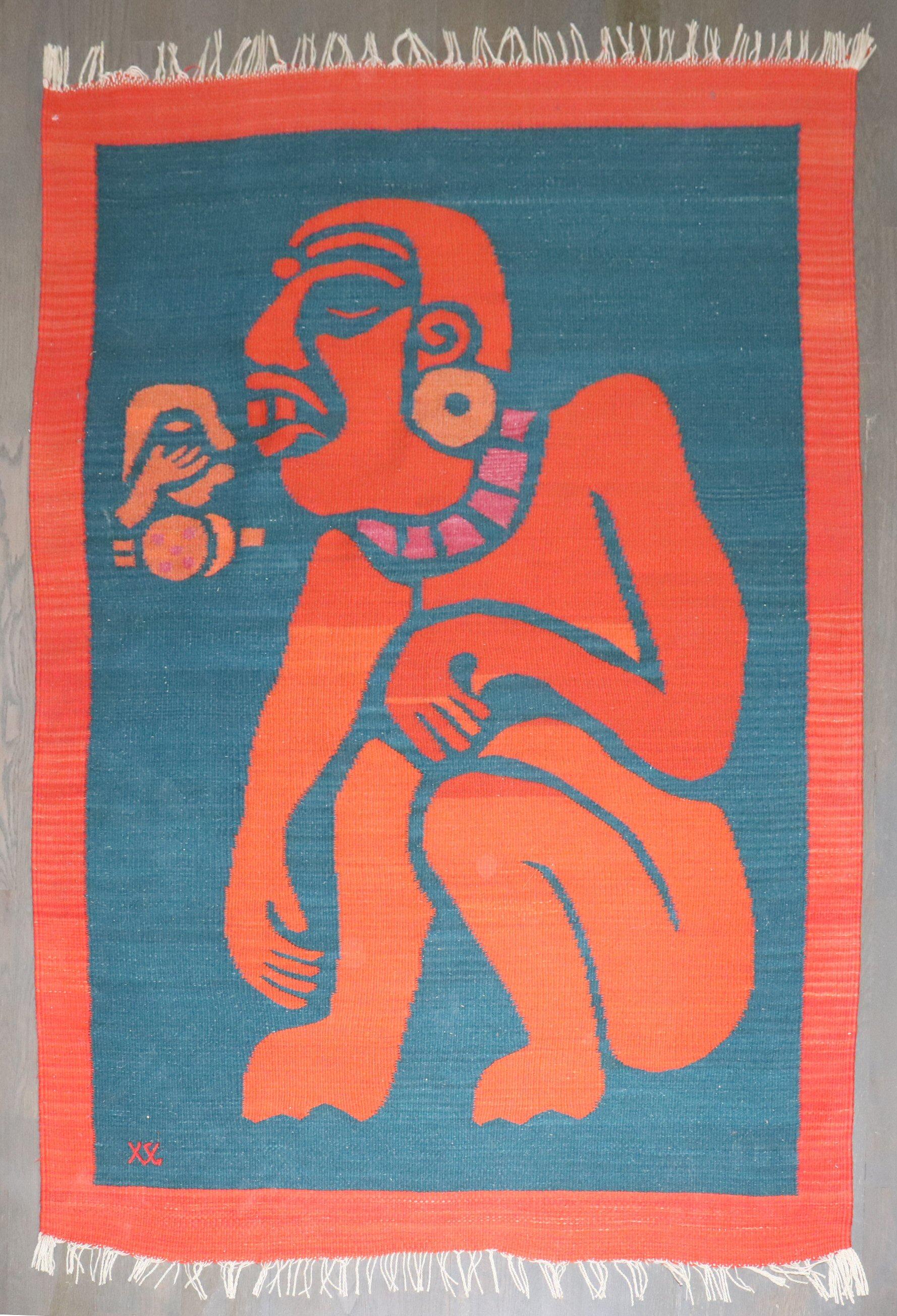 Hand-dyed wool on cotton warp; A bold and expressive handwoven wool tapestry from the Zapotec weaving tradition of Teotitlán del Valle, Oaxaca. This piece features a stylized Mesoamerican figure rendered in vivid red and orange tones against a deep