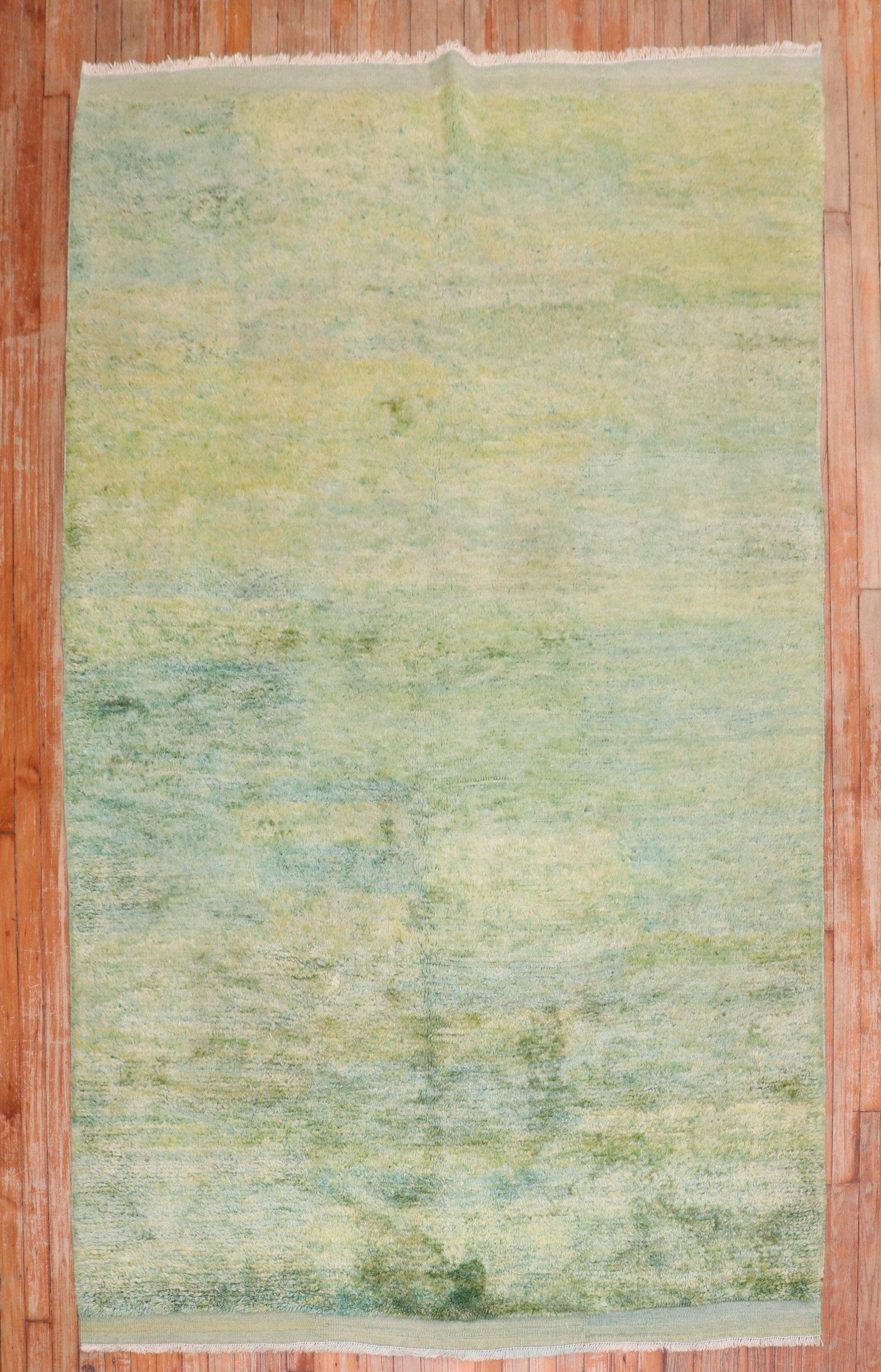 Minimalist mid-20th century Turkish Tulu rug with a plain striated green field

Measures: 5'4'' x 8'8''.