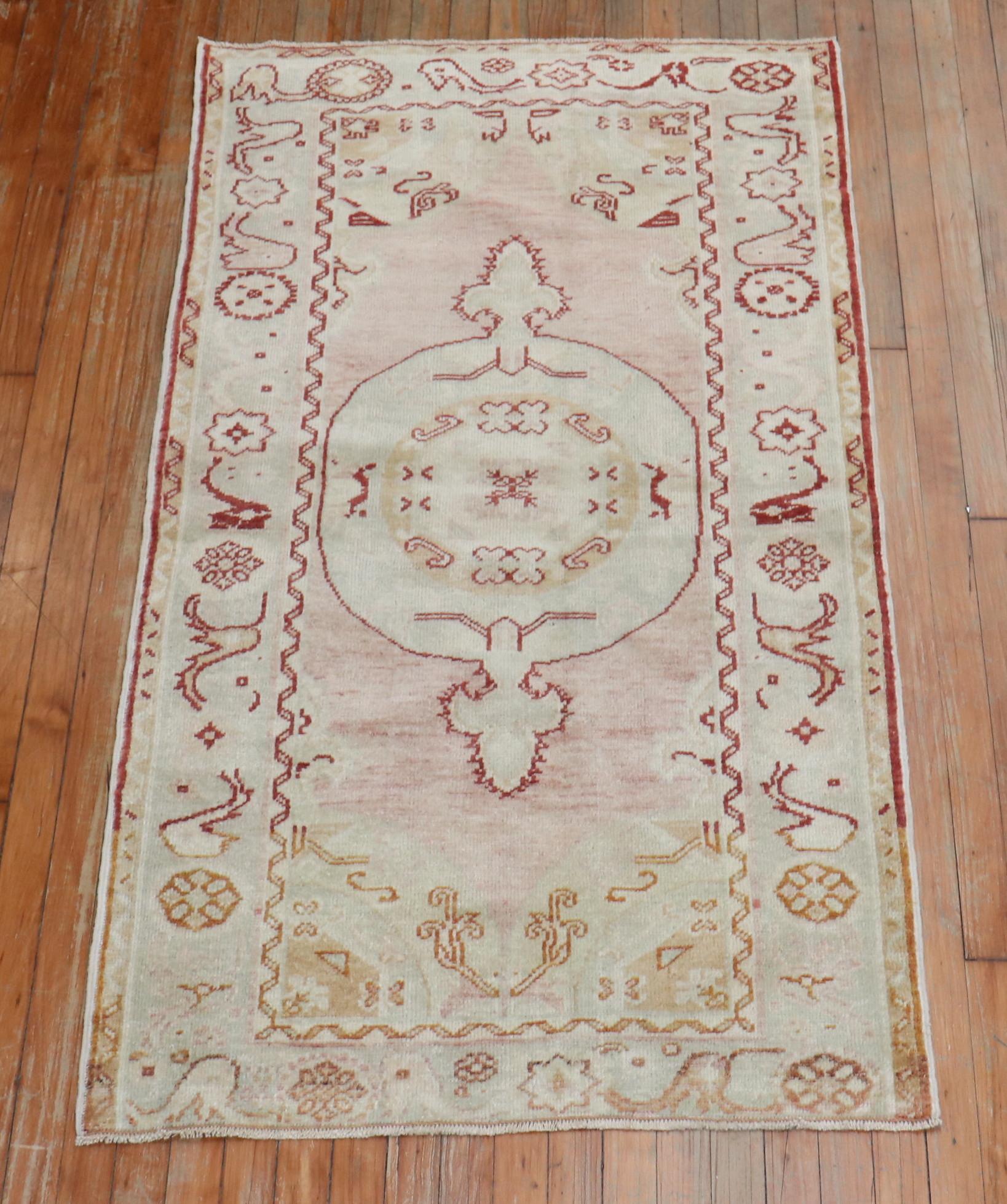 Oushak turco della metà del XX secolo con un campo rosa tenue, delineato da un rosso intenso.

Dettagli
rug no.	31522
dimensione	3' 1