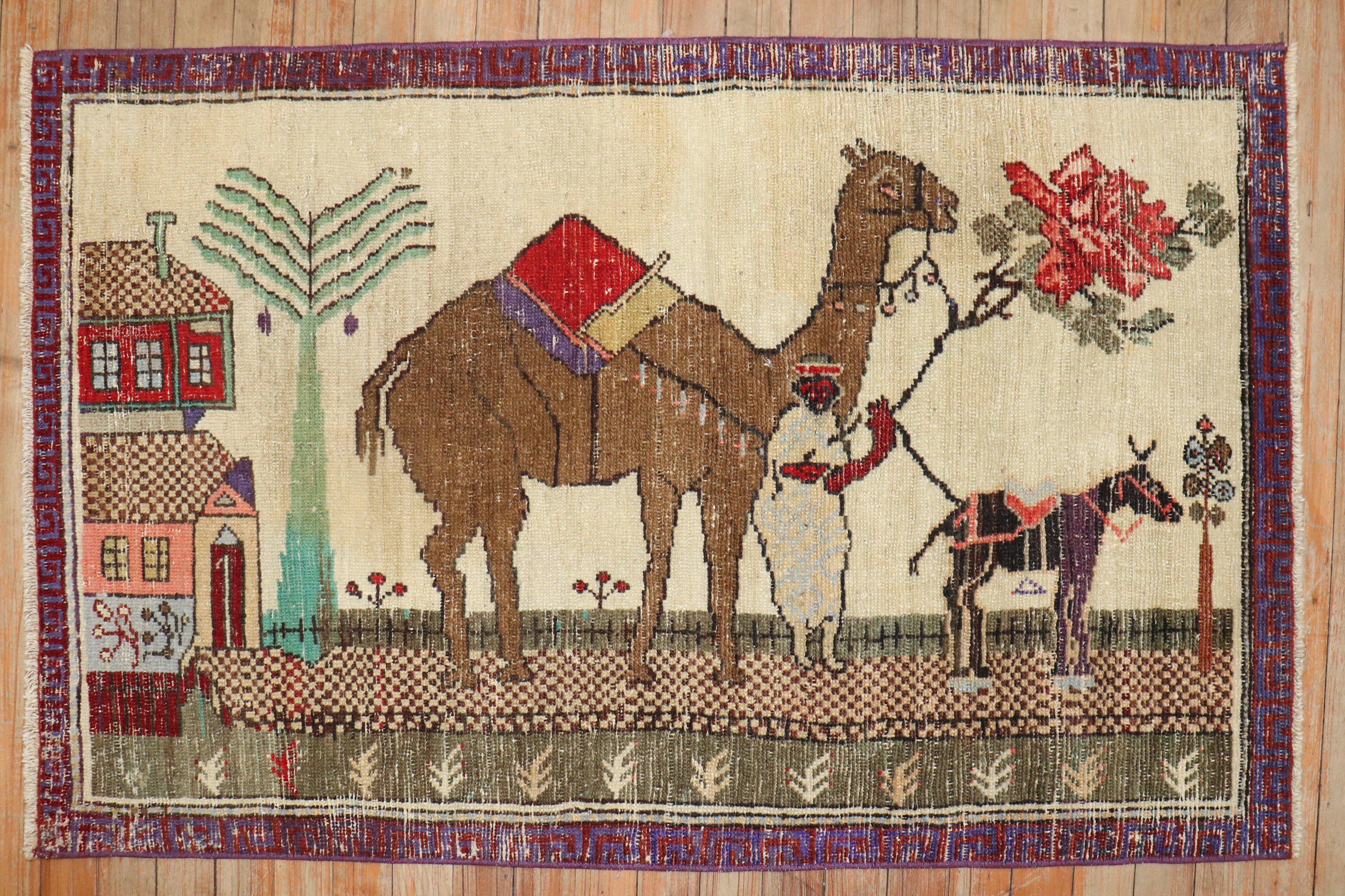 Mid-20th century colorful worn Turkish rug depicting camel and donkeys on an ivory ground.

Size: 2'5'' x 3'11''.