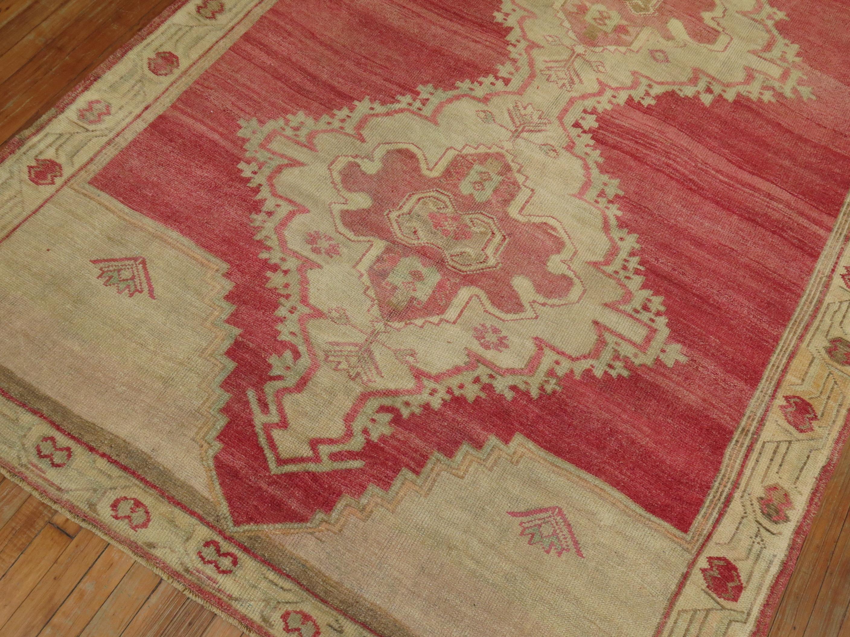 A gallery size mid 20th century Turkish Rug with 3 large medallions on a bright pinky red field

Details
rug no.	31391
size	6' 1