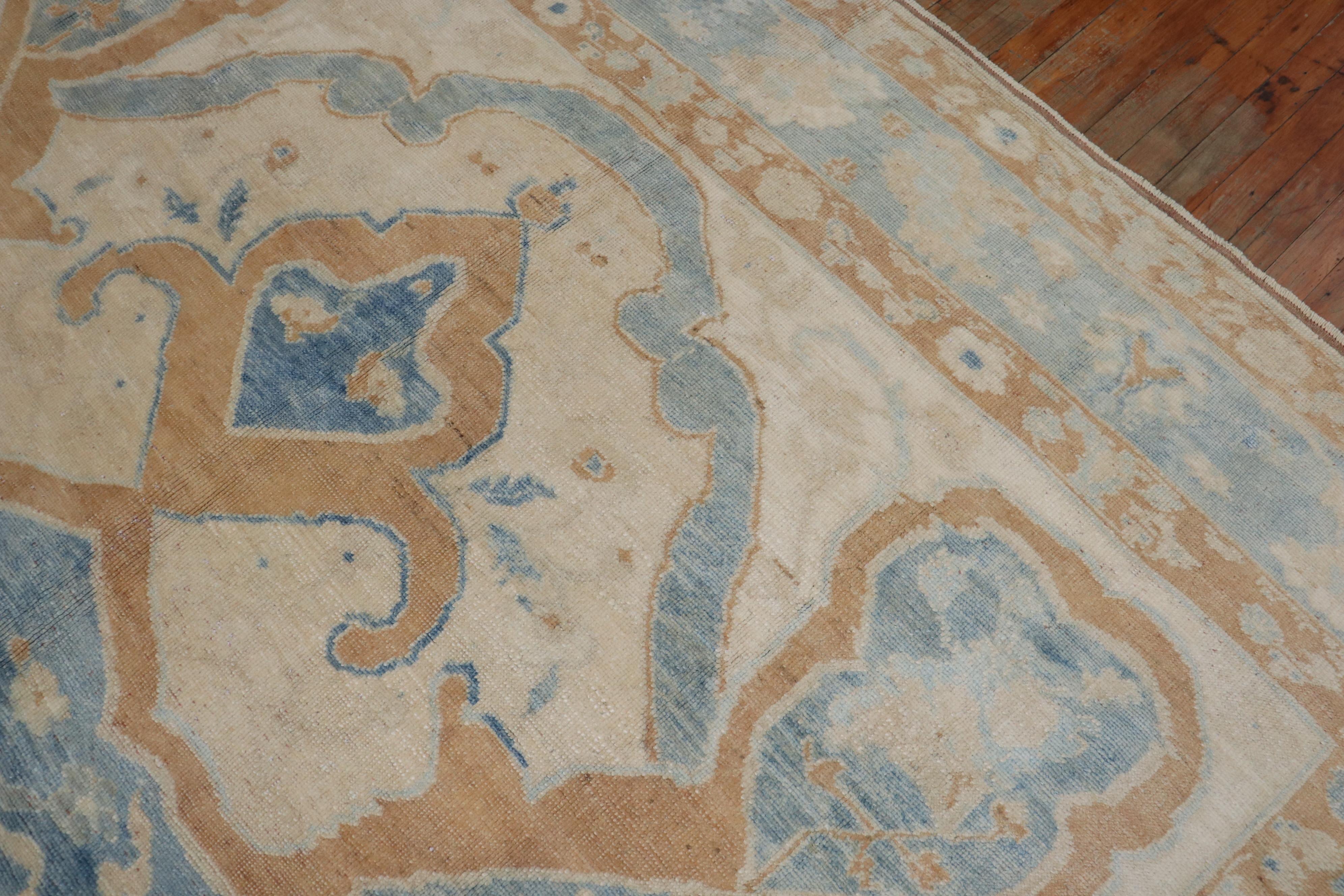 Room size vintage Turkish Rug win blue and bronze accents on an ivory field.

Details
rug no.	31504
size	10' x 12' 6