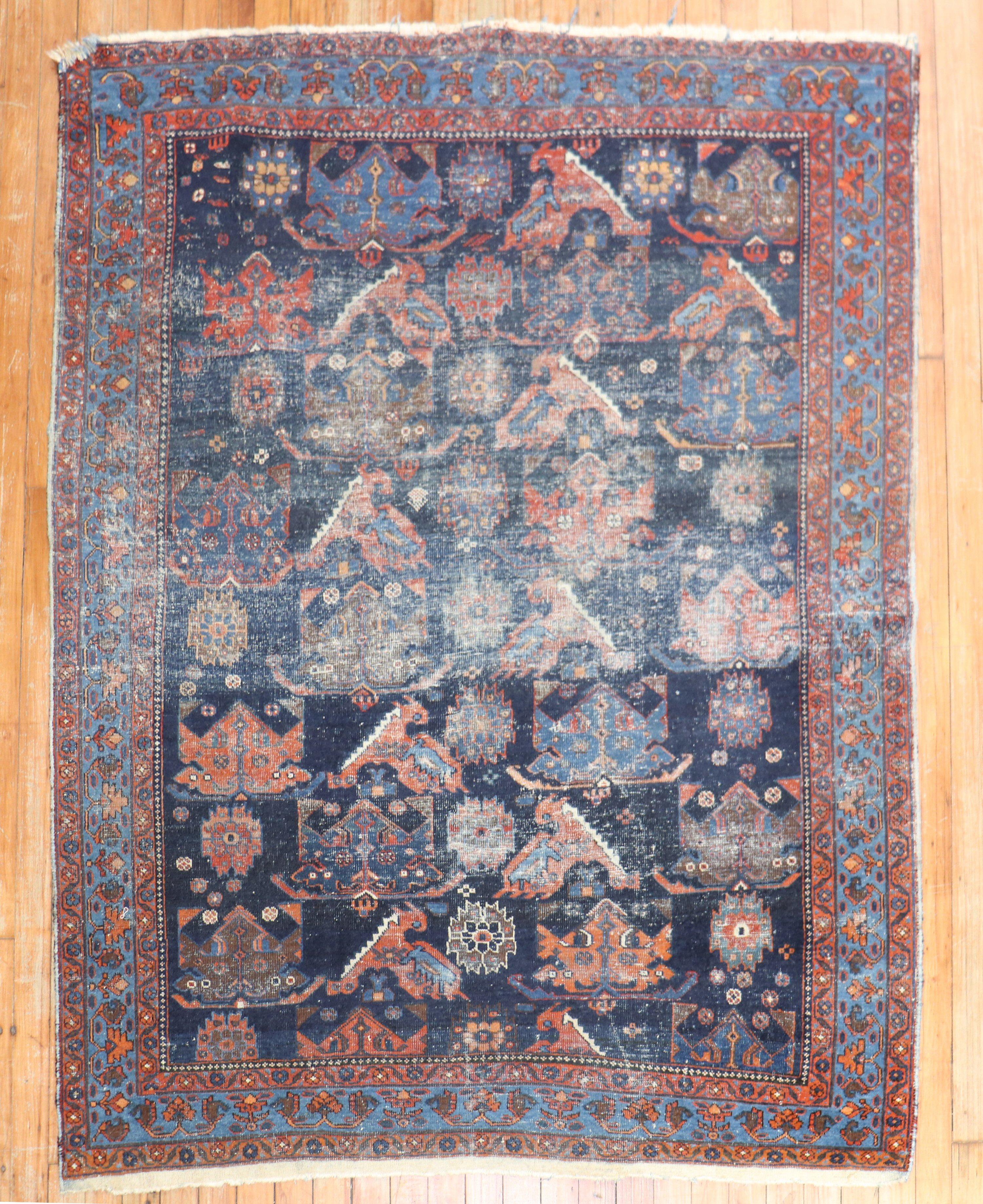 An early 20th-century worn Persian square tribal rug

Measure: 4'6'' x 5'7''.