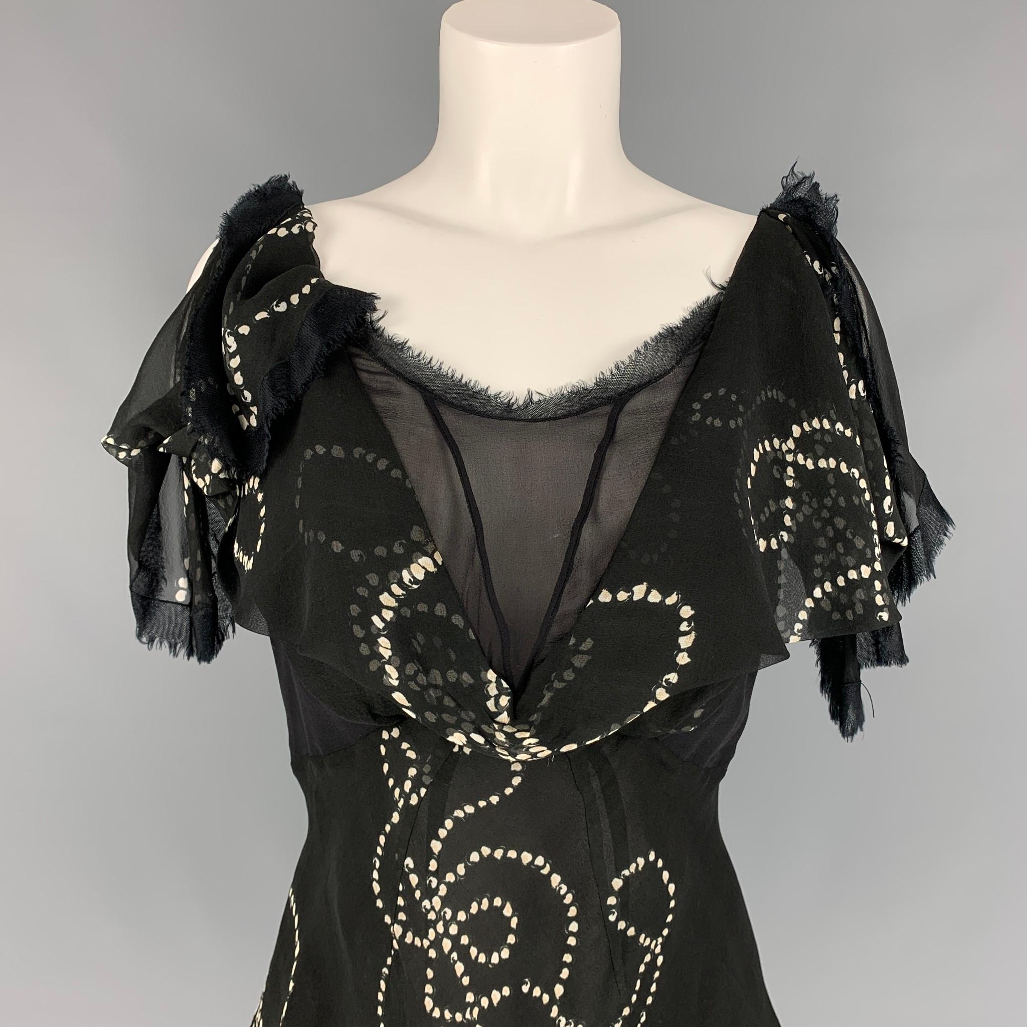 ZAC POSEN sleeveless blouse comes in a black & white chiffon silk featuring ruffled designs, raw edge, and a back zip up closure. 

Very Good Pre-Owned Condition.
Marked: 10

Measurements:

Bust: 34 in.
Length: 16 in. 