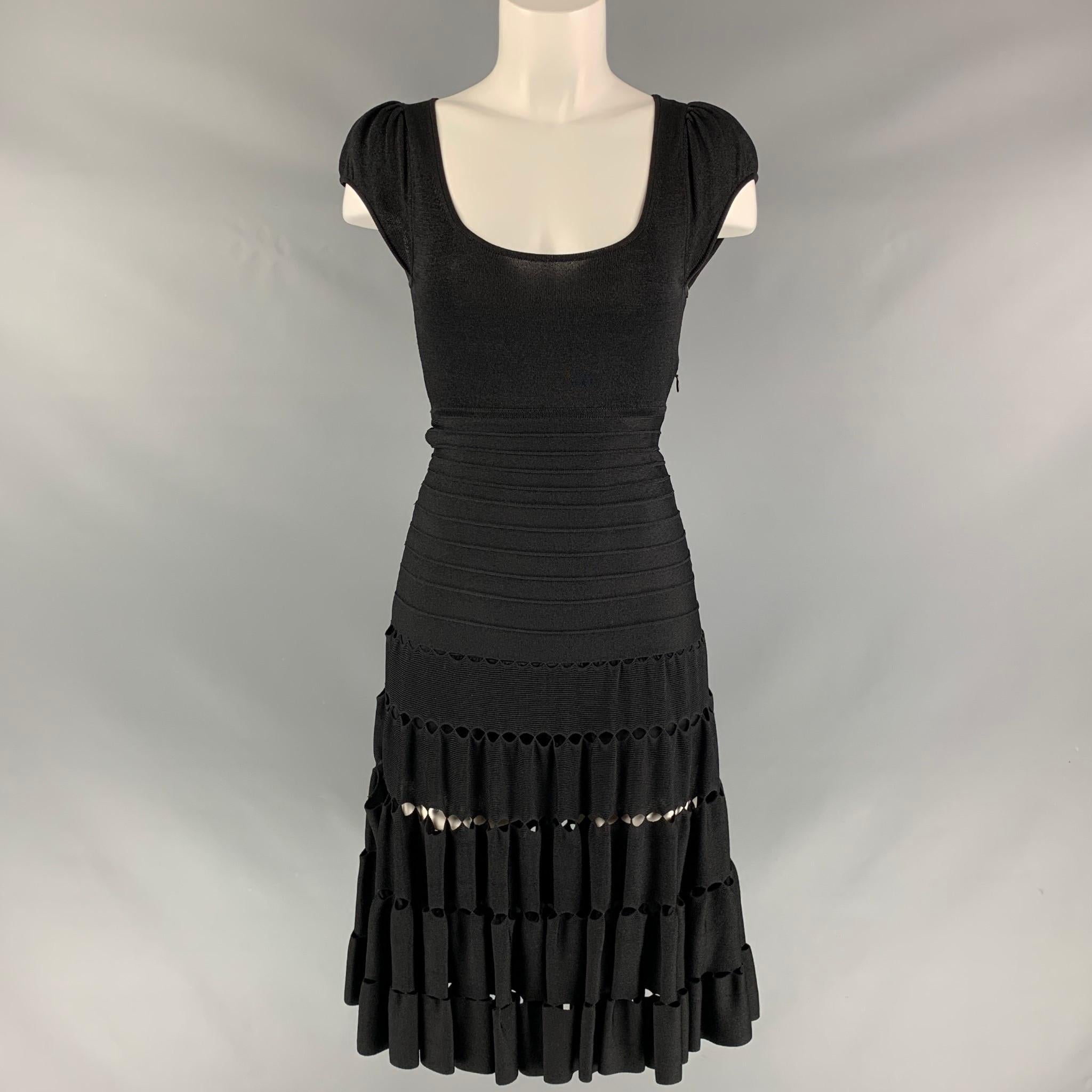 ZAC POSEN short sleeve dropped waist dress comes in black knitted viscose blend fabric, scoop neck and cut out details at the skirt.

Very Good Pre-Owned Condition.
Marked: XS

Measurements:

Shoulder: 13 in
Bust: 30 in
Waist: 24 in
Hip: 28