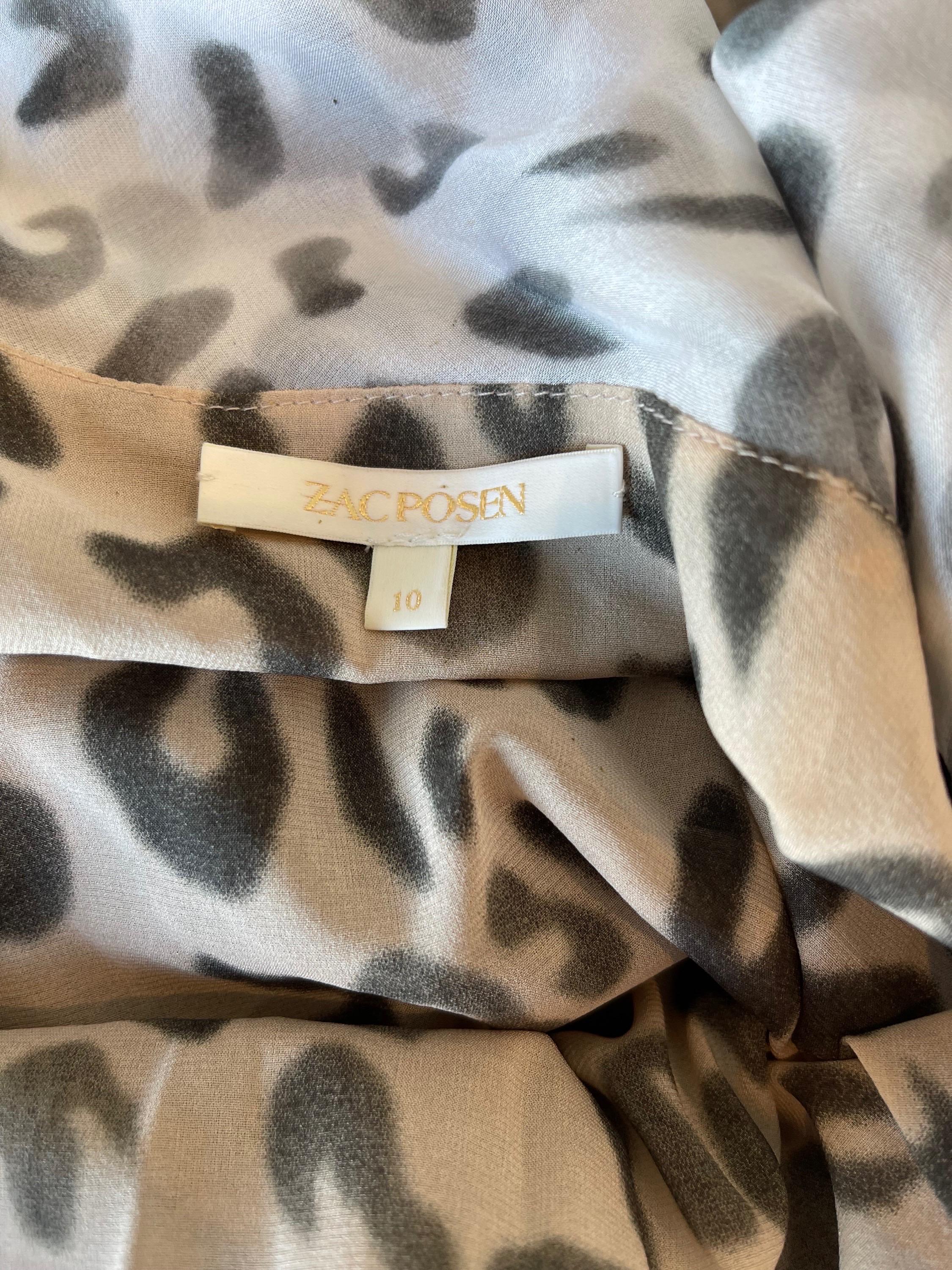 Chic ZAC POSEN Spring 2009 snow leopard print silk sleeveless shirt ! Features beautiful, flattering drapes with gray and white leopard spots. Simply slips on over the head. Can easily be dressed up or down. Pair with jeans or shorts for day, or