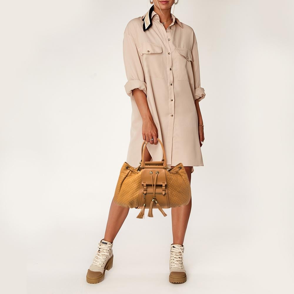This handbag from Zac Posen is a true masterpiece that will elevate your ensembles and make you the talk of the town. It is crafted from quality leather in Italy and comes in a lovely tan hue. It is styled with dual handles, exterior zip pockets,