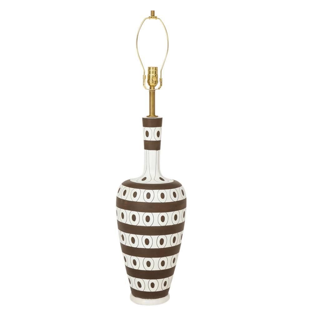 Zaccagnini lamp, ceramic, stripes, dots, white, brown, signed. Tall pottery lamp decorated with an African influence of alternating patterns of chocolate brown horizontal stripes and circled dots over a white glazed body. Signed: Z Italy L1194 on