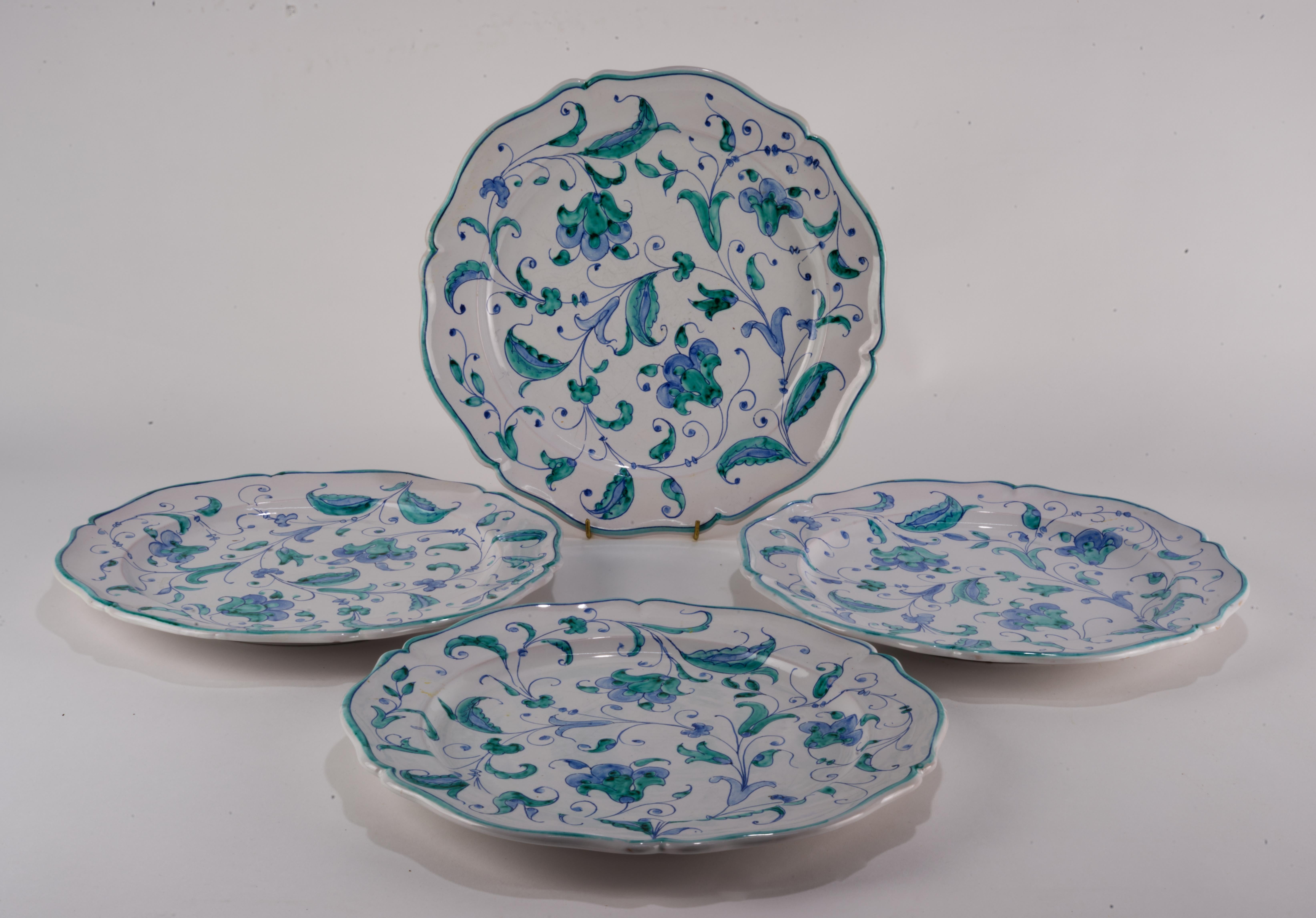 
Set of 4 dinner plates was made in Florence, Italy by Società Anonima Ceramiche Zaccagnini. The plates are decorated in traditional style with teal and blue plant-based pattern on white background and elegant ornamental rim.

The plates are signed
