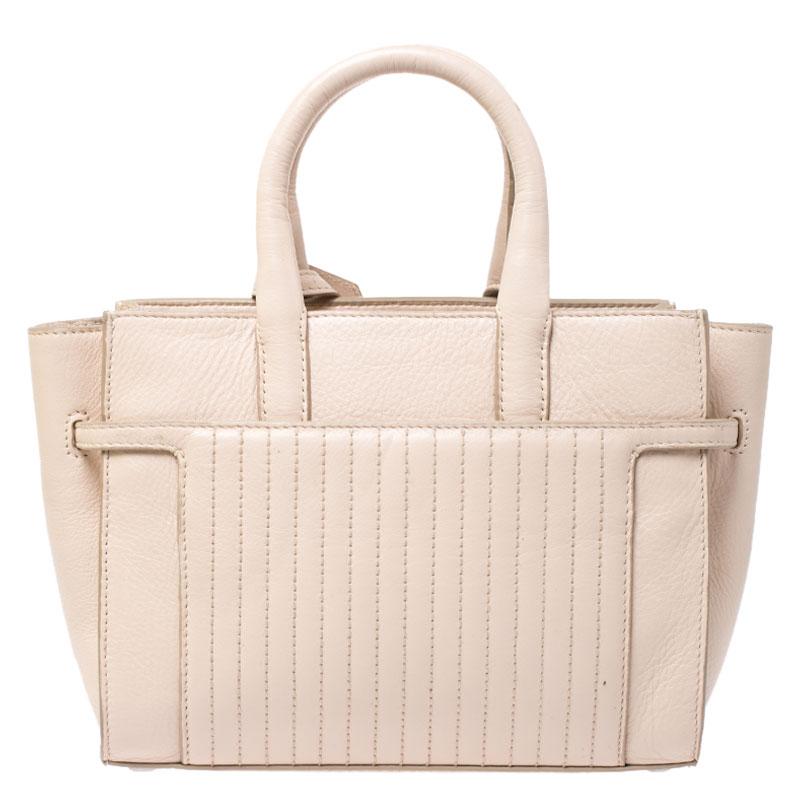 Zadig and Voltaire bring you this gorgeous Candide bag that carries a grand structure and a minimal design. It features a spacious fabric interior, a padlock detail, and protective metal feet. You can use the two handles or the shoulder strap to
