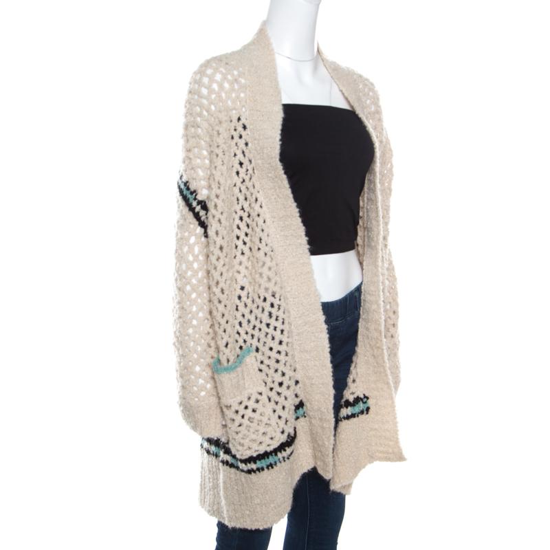 This cream cardigan from Zadig and Voltaire is so stylish, you'll find reasons to wear it! It is made of a merino wool blend and features a crochet knit design. It flaunts a relaxed open front silhouette, slip pockets and long sleeves. Grab it right