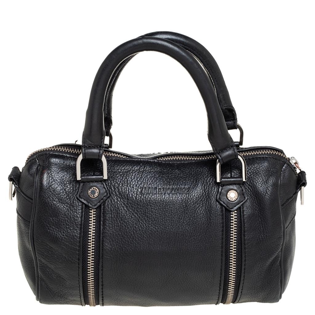 Zadig & Voltaire is known for its quality craftsmanship and designs. Embrace your natural stylish self and deliver exquisite looks with this alluring leather handbag. A symbol of style and shape, the interior is lined with fabric. It has a black