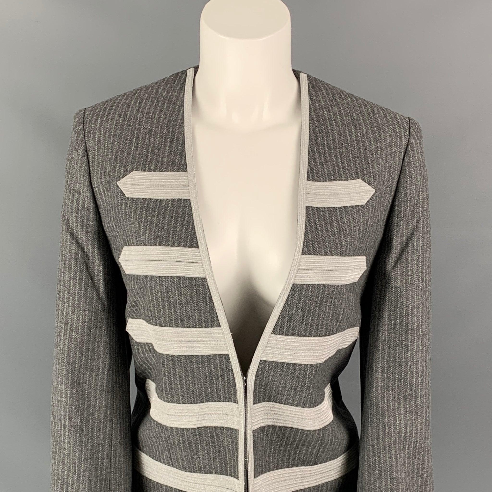 ZADIG & VOLTAIRE coat comes in a grey & silver pinstripe wool blend with a full liner featuring a military style, collarless, and a hook & loop closure.
New With Tags.
 

Marked:  40 

Measurements: 
 
Shoulder:
15.5 inches Bust: 38 inches Sleeve: